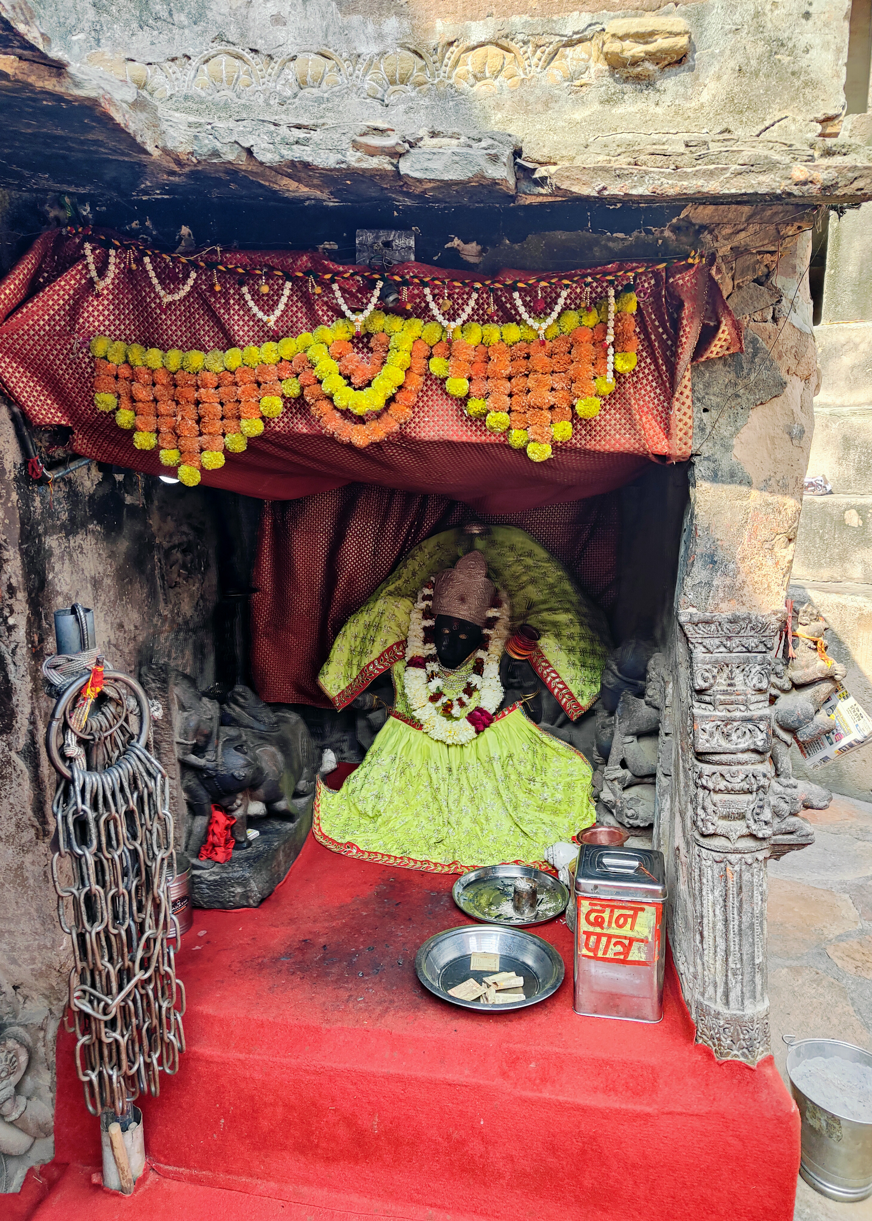 Image 11: Black paint and cloth have smeared this image of Durga Mahisasuramardini in active worship, obscuring its details. It is one of the many images contemporaneous to the Harsha shrine, affixed in the enclosure of the Bhairon shrine.