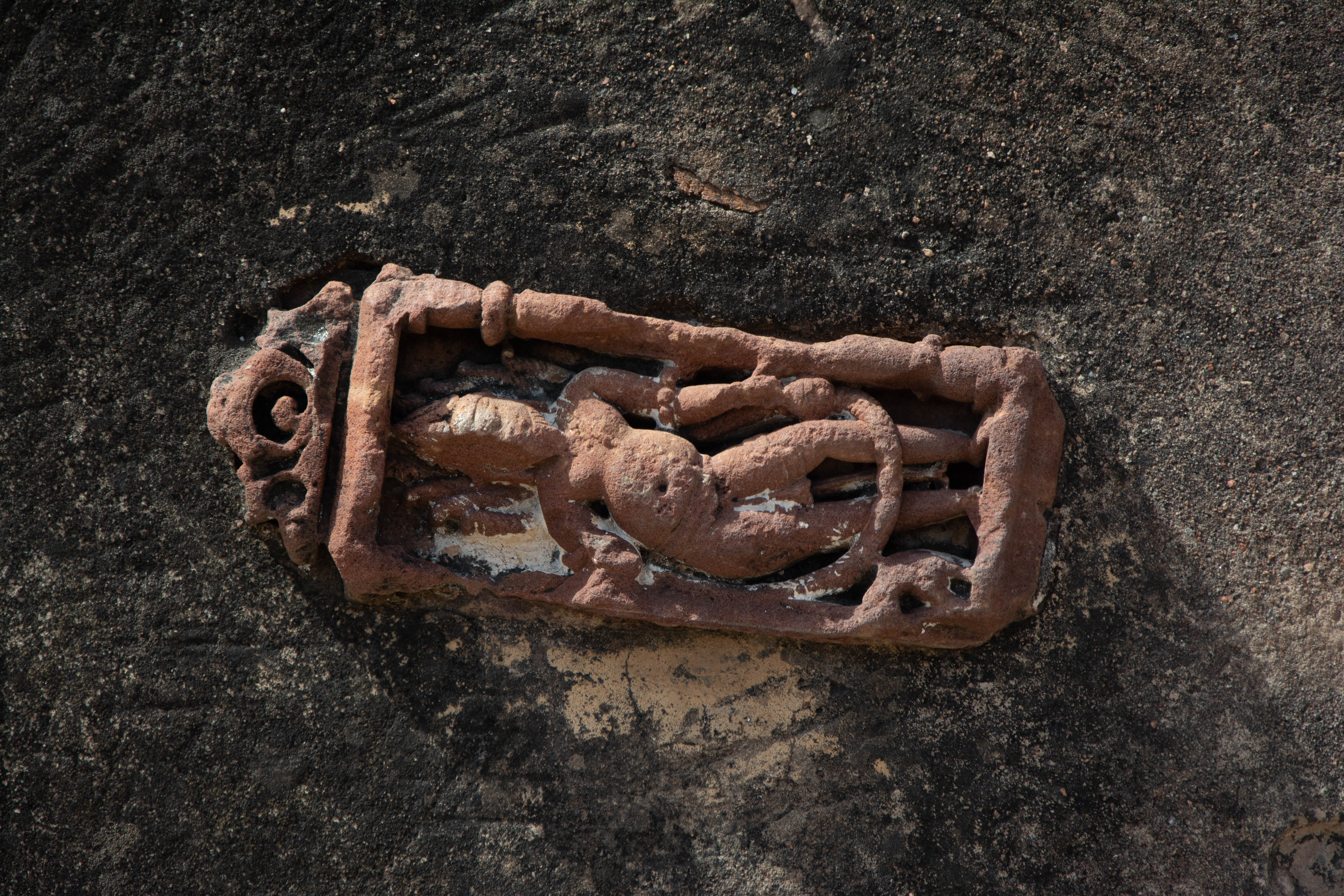 It is likely a figure of the dikpala Agni (the God of Fire) holding a kamandalu (pot) in his left hand. On Harsha Hill, a late medieval structure now bears the image of a directional deity that once adorned the temple wall.