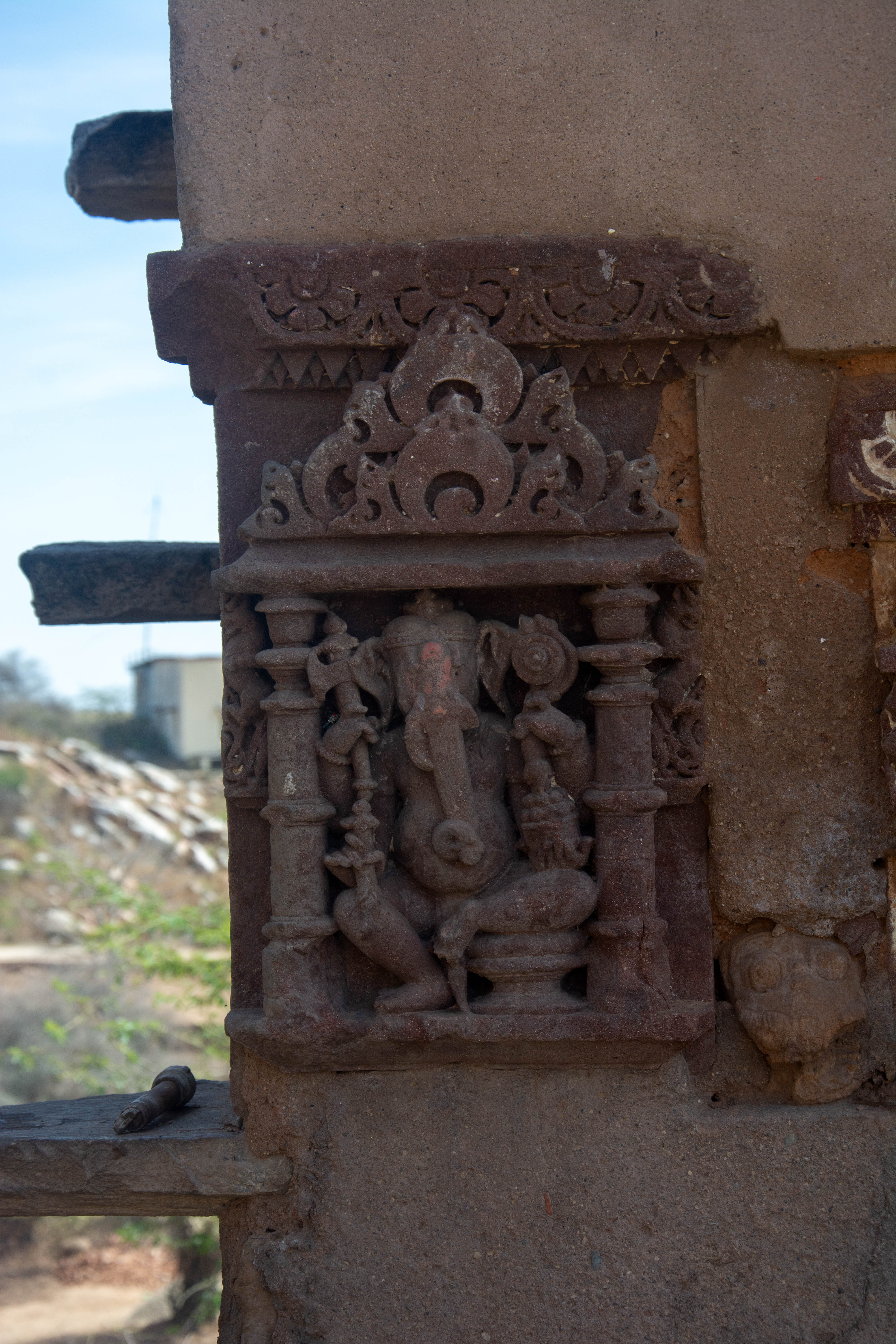 The lalitasana posture depicts a four-armed Ganesha holding an axe, lotus, bowl of sweets, among other attributes.