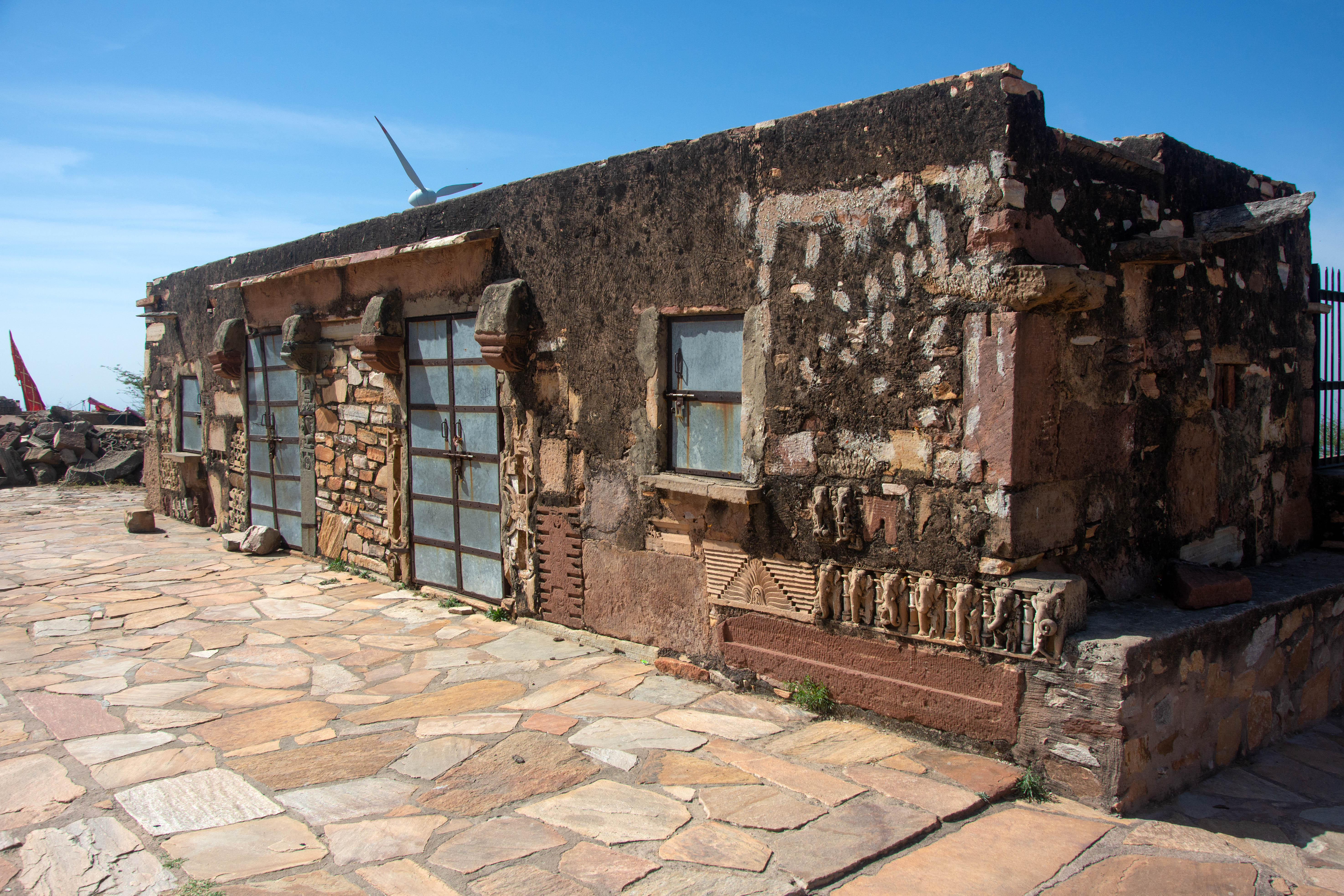 One notable architectural fragment affixed to the structure is a row of elephants (seen below the closed window), which must have once been part of the temple’s base moulding.