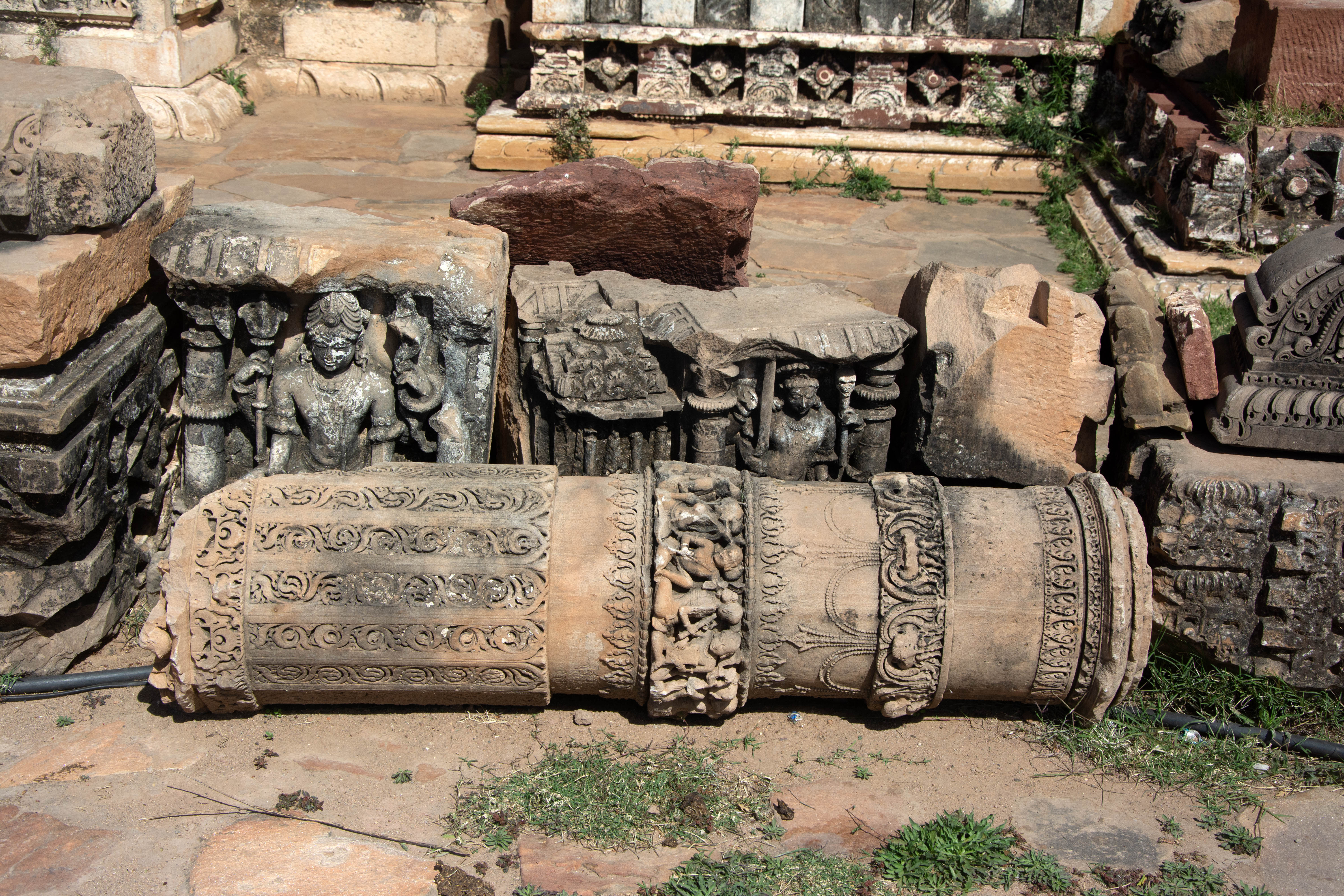 The loose architectural fragments in front of the Harshnath Temple include a pillar with a band of dancers and musicians; a four-armed image of Shiva, which was once part of a devakostha niche, featuring a snake and a trident in the two hands above; and another niche of smaller size depicting Bhairav holding a sword and a skull-headed spear.