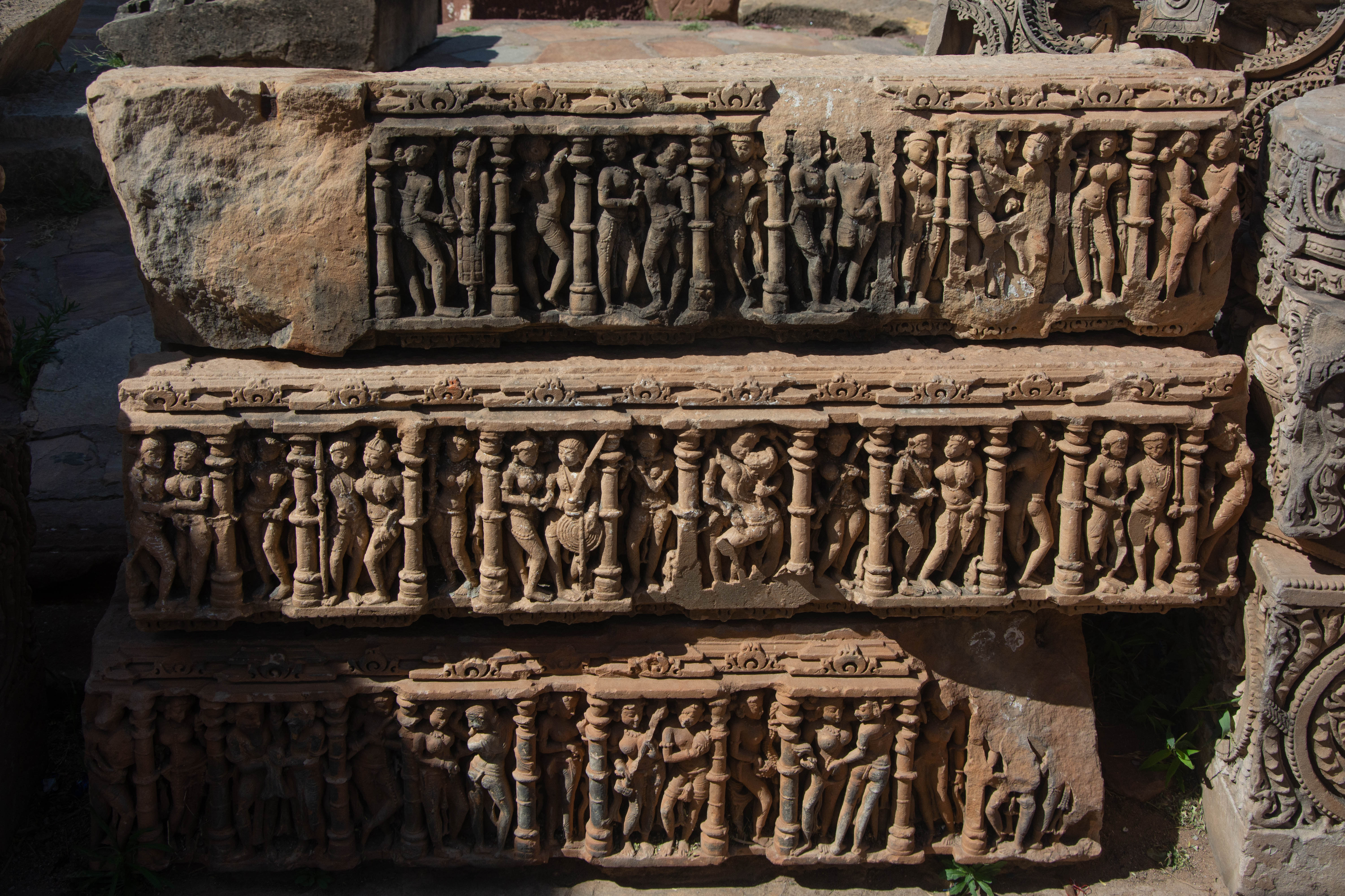 It is likely that the beam, richly carved with human figures, adorned the temple's varandika and the adjoining portions between the temple walls and the spire. Typically, the protruding offsets house mithuna figures within the niches, and the recesses between the two offsets showcase exquisite carvings of apsaras.