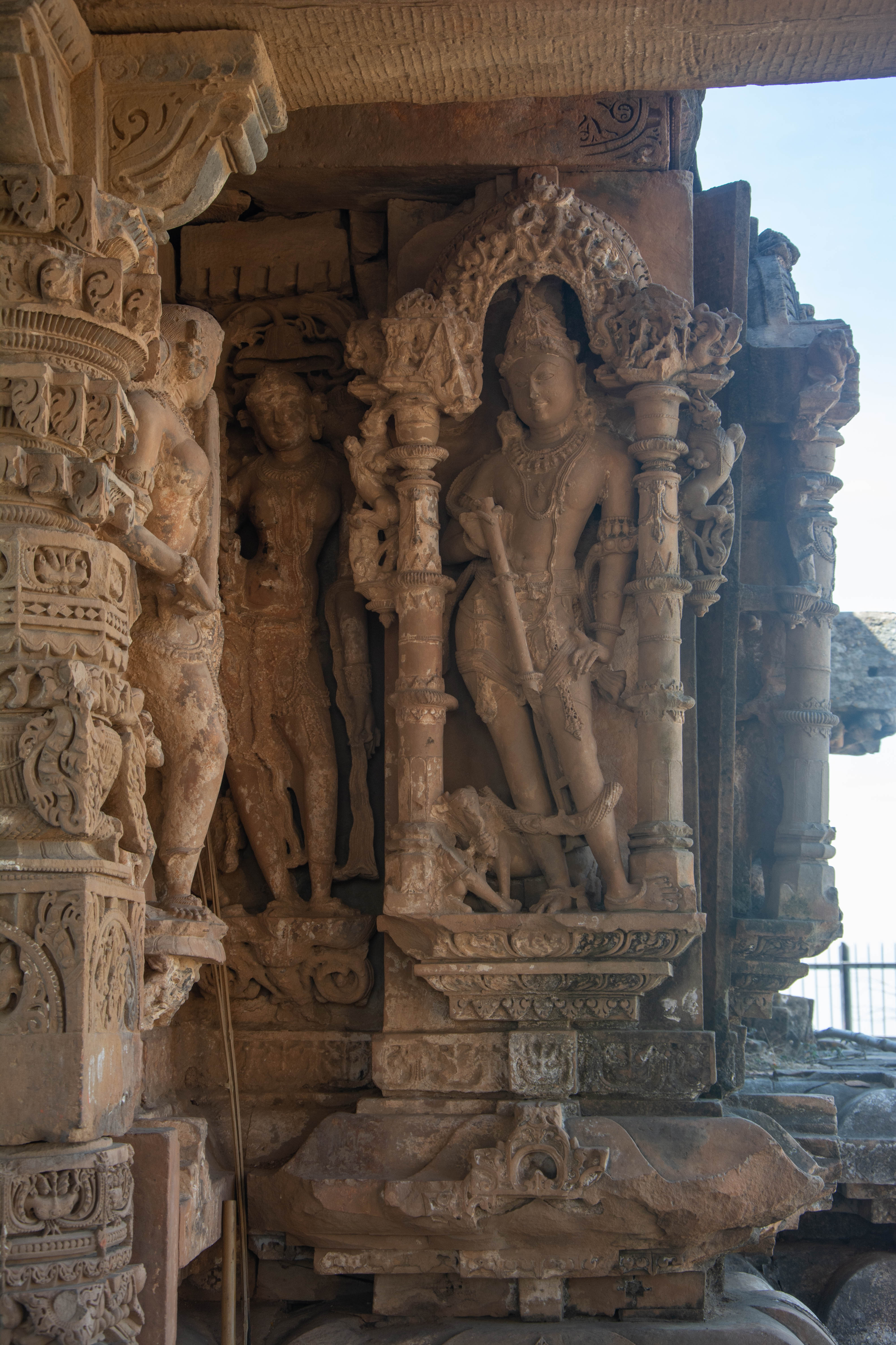 The Harshnath Temple wall depicts dikpala Ishana with his vahana, a bull, on the northeast corner. A dwarf figure feeding the bull from a vessel is an intriguing feature of the image. A dwarf figure feeding the bull from a vessel is an intriguing feature of the image.