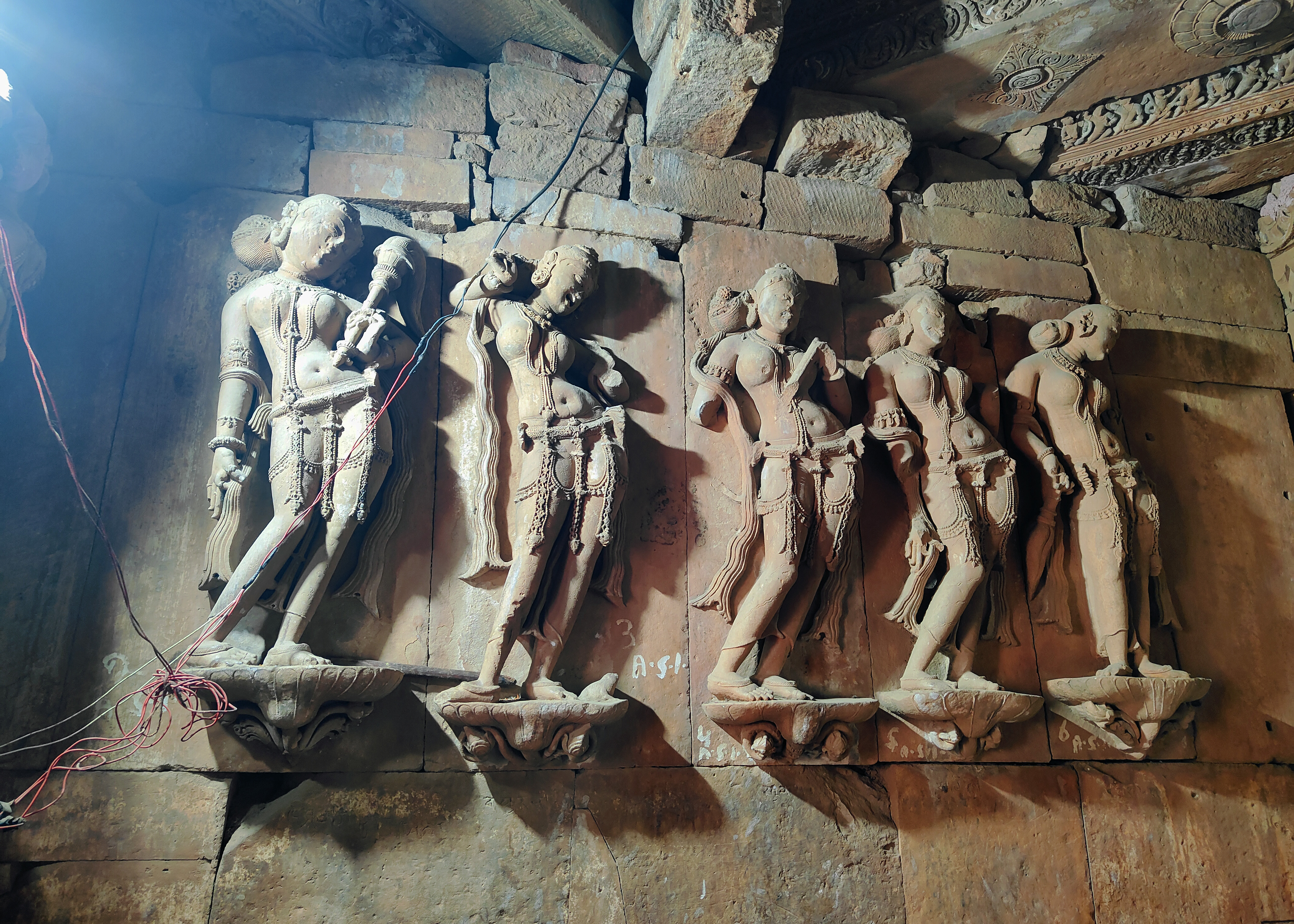 The walls of the Harshnath Temple's sanctum are adorned with exquisite Nayika sculptures. The Kutila script of the 10th century CE inscribes epithets on most of them.