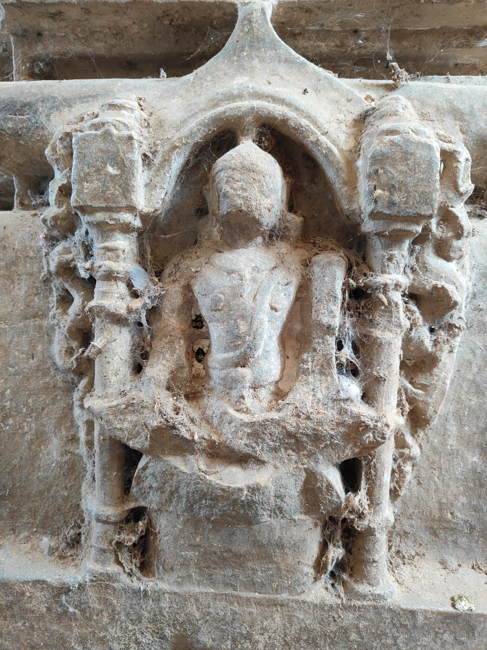 Image 5: Lakulisha holding his club and fruit in a seated posture.