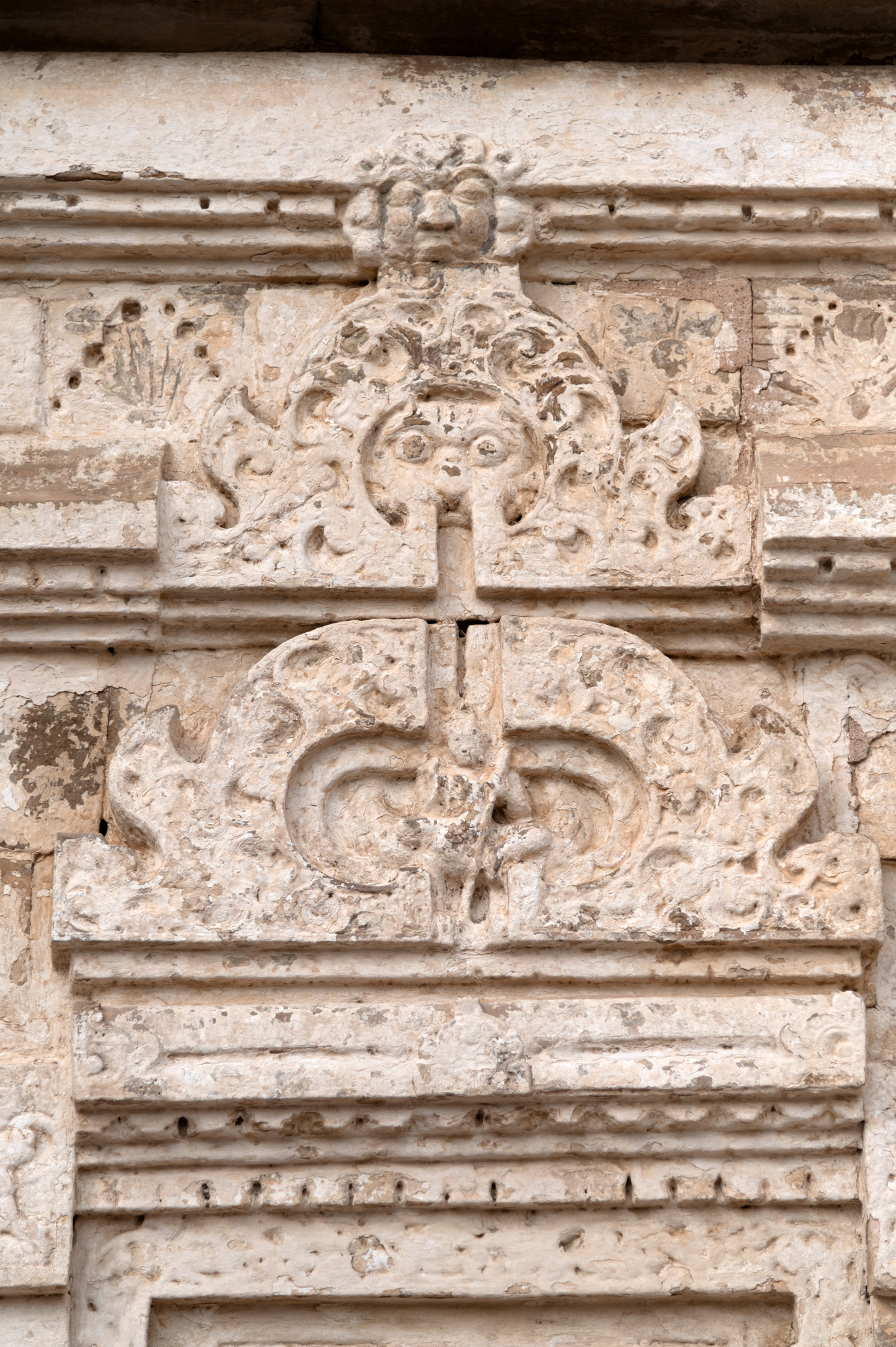 The double Chaitya arch on the southern side shows Kartikeya in the lower arch. Seated on a peacock, he holds a spear.