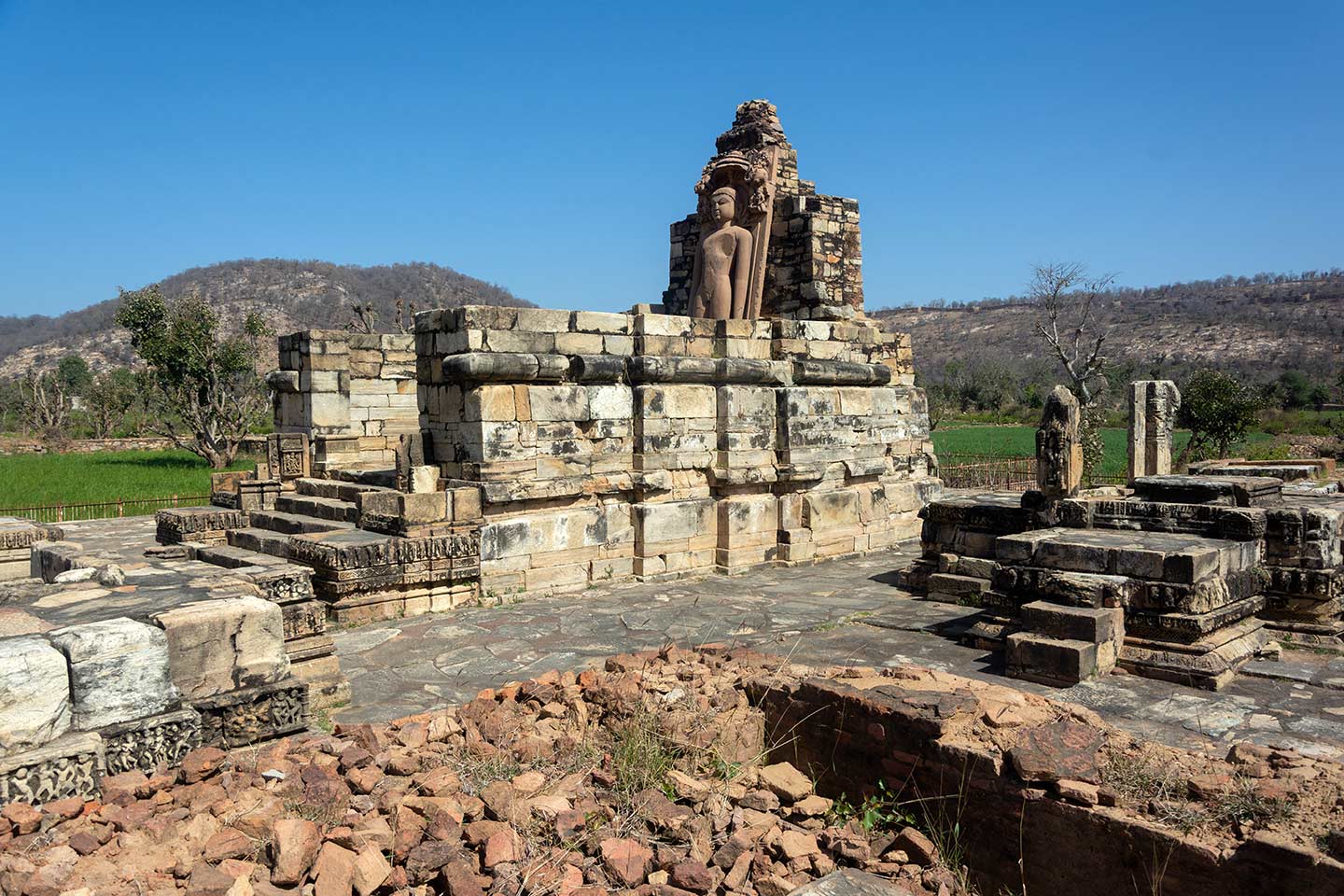 Image 3: This is a closer view of the Naugaza Shantinatha Temple along with the ancillary structures. From the plinth remains, it appears that it was a temple with a pancharatha (five projections on each side) plan, minimal sculptural depictions but intricate geometric patterns. There are remains of smaller temples to the north and east of the temple. Several architectural elements from the temples are scattered in the vicinity of the Naugaza Temple.