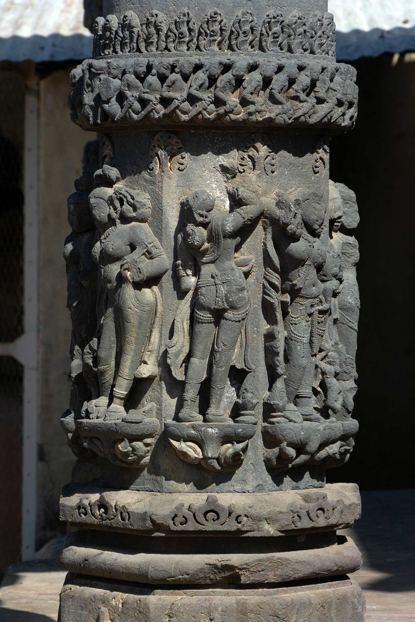 A closer view of the sculptures on the base of the pillar of the mukhamandapa (front porch). These sculptures are primarily made of surasundaris (celestial damsels). The base of the pillar has mouldings that resemble the kumbha (pot), kalasha (a pitcher), and kapotali (cyma recta) mouldings in a temple plinth.