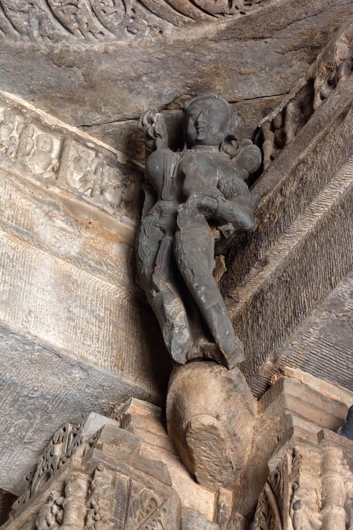 The central pillars of the mandapa (pillared hall) in the Neelkanth Mahadev Temple have depictions of surasundaris (celestial damsels) as female bracket figures above the pillar capitals. These figures are in all four corners of the ceiling. The female figures, carved in a different stone, contrast with the pillars, lintels, and walls of the temple interiors.