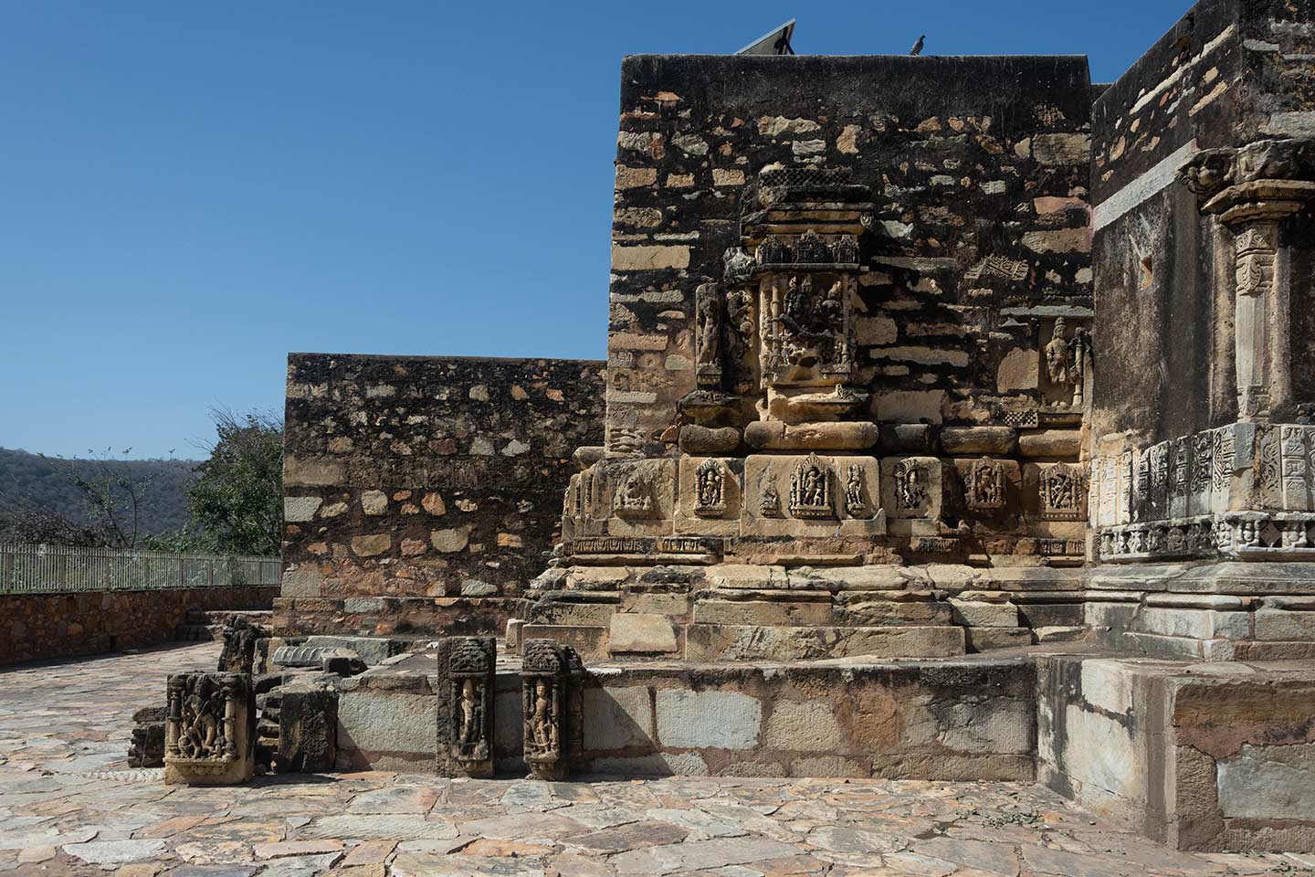 This is the view of the rear elevation of the southern shrine of the triple-shrine Neelkanth Mahadev Temple. The exterior walls of this shrine have completely collapsed and were replaced at a later point with incongruously added wall portions. In rebuilding these walls, architectural members of the original temple have been repurposed haphazardly.