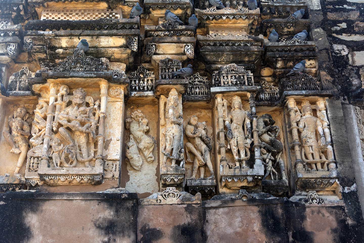 This is the north-facing elevation of the central shrine in the Neelkanth Mahadev Temple. The central bhadra (central projection) depicts Narasimha killing the demon Hiranyakashipu. The recesses have figures of vyala (composite mythical creatures) and mithuna/maithuna (amorous couples).