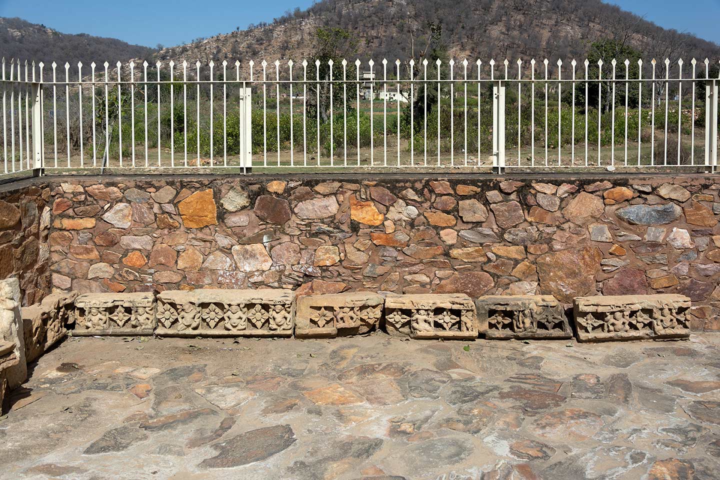 Inside the boundary wall of the Neelkanth Mahadev Temple premises, there is a row of broken mouldings with diamond designs. These sections must have been part of the temple's original plinth.