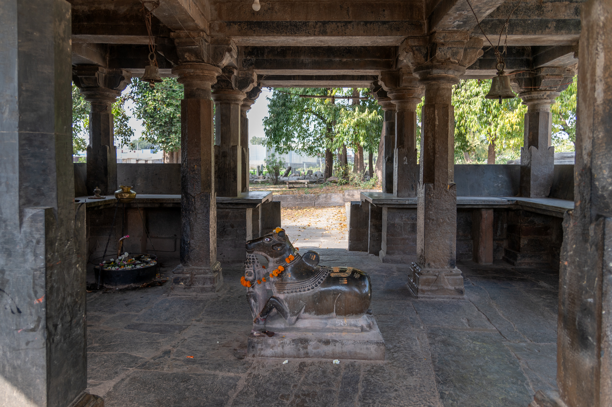 The Neelkanth Mahadev Temple has a semi-open mandapa (pillared hall). It has four pillars at its center, as well as dwarf walls all along its sides. There is a Nandi sculpture on a pedestal at the center of the mandapa, facing the garbhagriha (sanctum sanctorum). The mandapa's pillars and interior walls are simple.