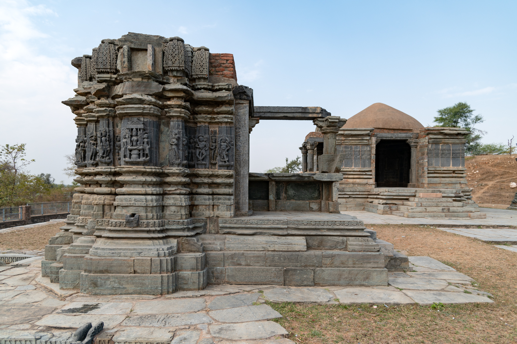 The Someshwar Mahadev Temple offers a view of the side shrine from the panchayatana, which is the main shrine surrounded by four cardinal subsidiary shrines. Not all of these shrines have survived, except for the ones to the northwest and southeast of the main temple. This is the shrine southeast of the main temple. The four side shrines in the complex are single shrines dedicated to different deities, probably Vishnu, Ganesha, goddess, and Surya. Of the shikhara (superstructure) on these shrines, only a few aedicules of the base have survived.