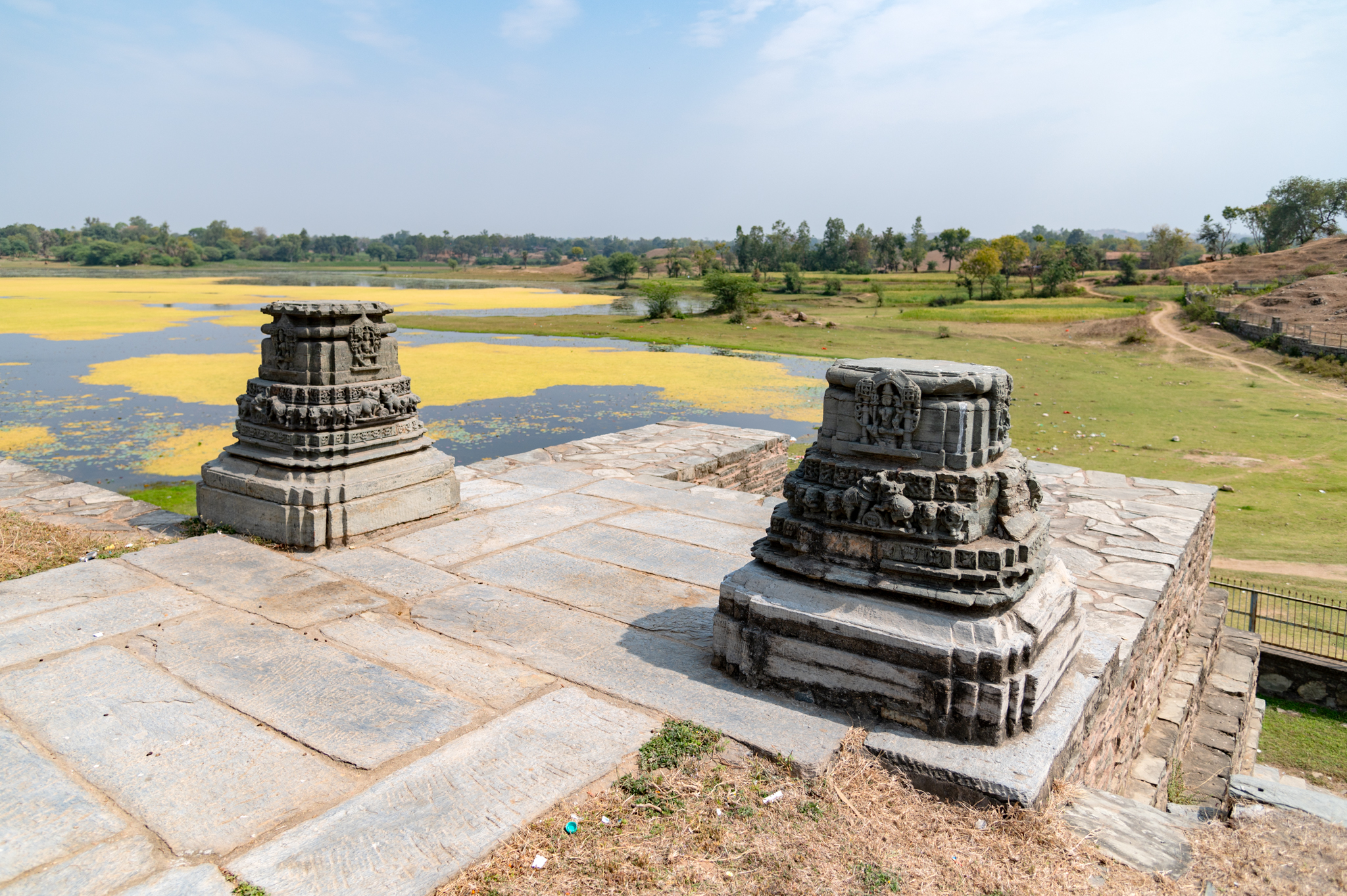 These are the remains of pillars at the east-facing entrance of the Someshwar Mahadev Temple. The two broken pillar bases must have formed the torana (decorative arch) as an entrance gateway to the complex. The complex had two toranas, one east of the temple and one north.