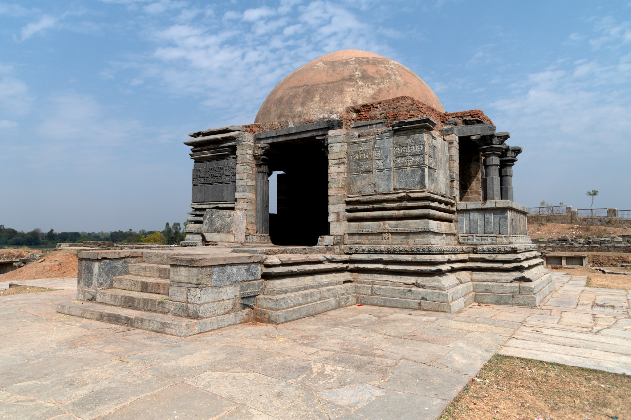 The Kumbheshwar Mahadev Temple's mandapa, or pillared hall, is square in plan. Its main entrance is to the west, and the south and north sides have lateral wings protruding. These wings are semi-open, like balconies. The mandapa's exterior walls have minimal ornamentation. A band of kirtimukhas (face of glory) and peepal leaf motifs are the only ornamentation patterns on the wall.