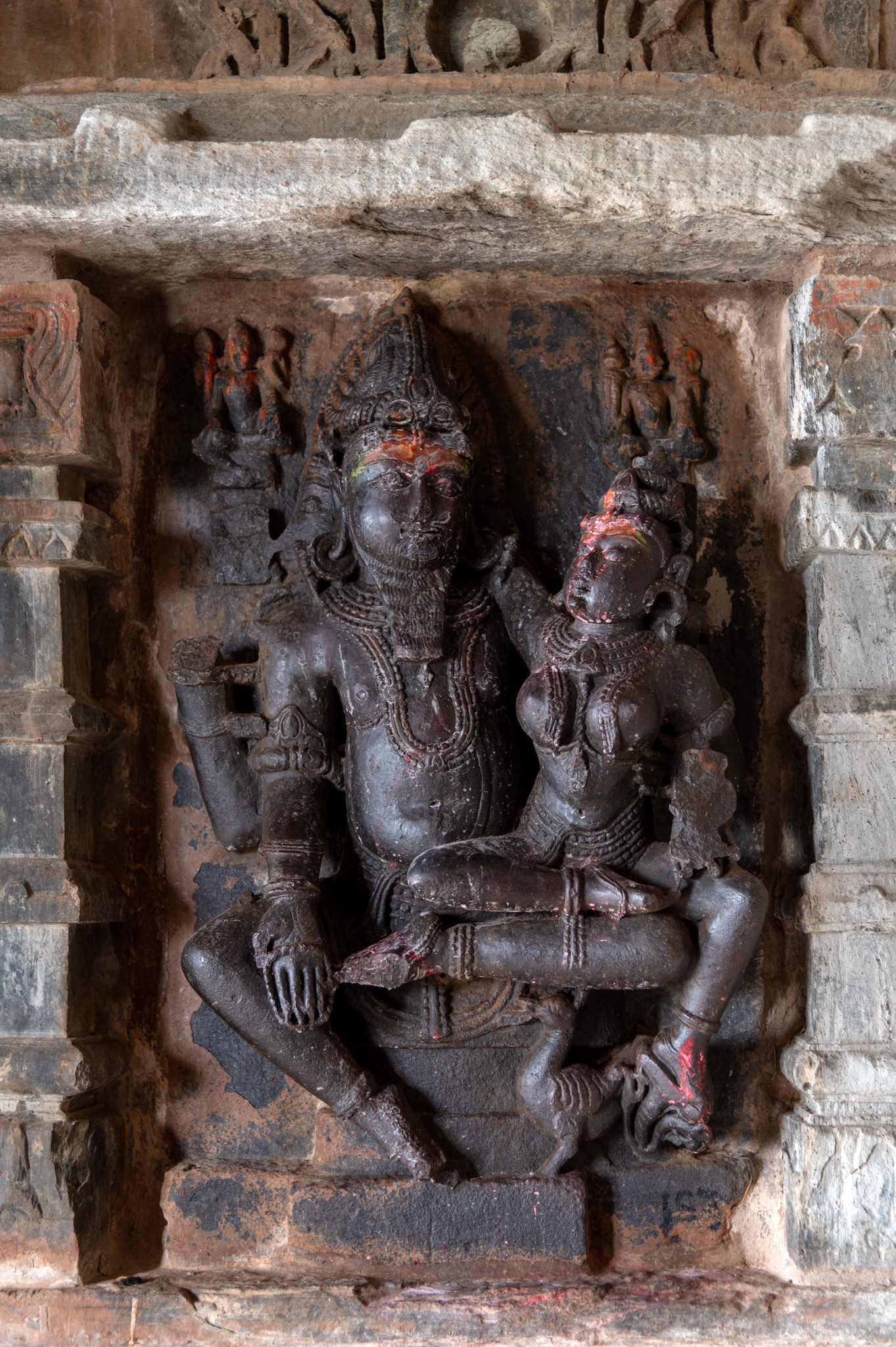 The interiors of the Kumbheshwar Mahadev Temple are austere, barring a few sculptures. One of the devakoshthas (niches) in the wall of the mandapa (pillared hall) has a deity with his consort, probably Uma Maheshwar.