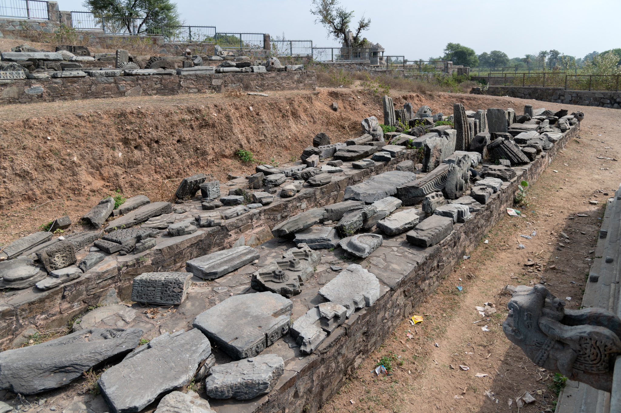 There are several architectural remains east of the Kumbheshwar Mahadev Temple complex. These were retrieved from the temple premises. The remains consist of pillars, lintels, plinth mouldings, shikhara (superstructure remains), pranala (water chute), among several others.