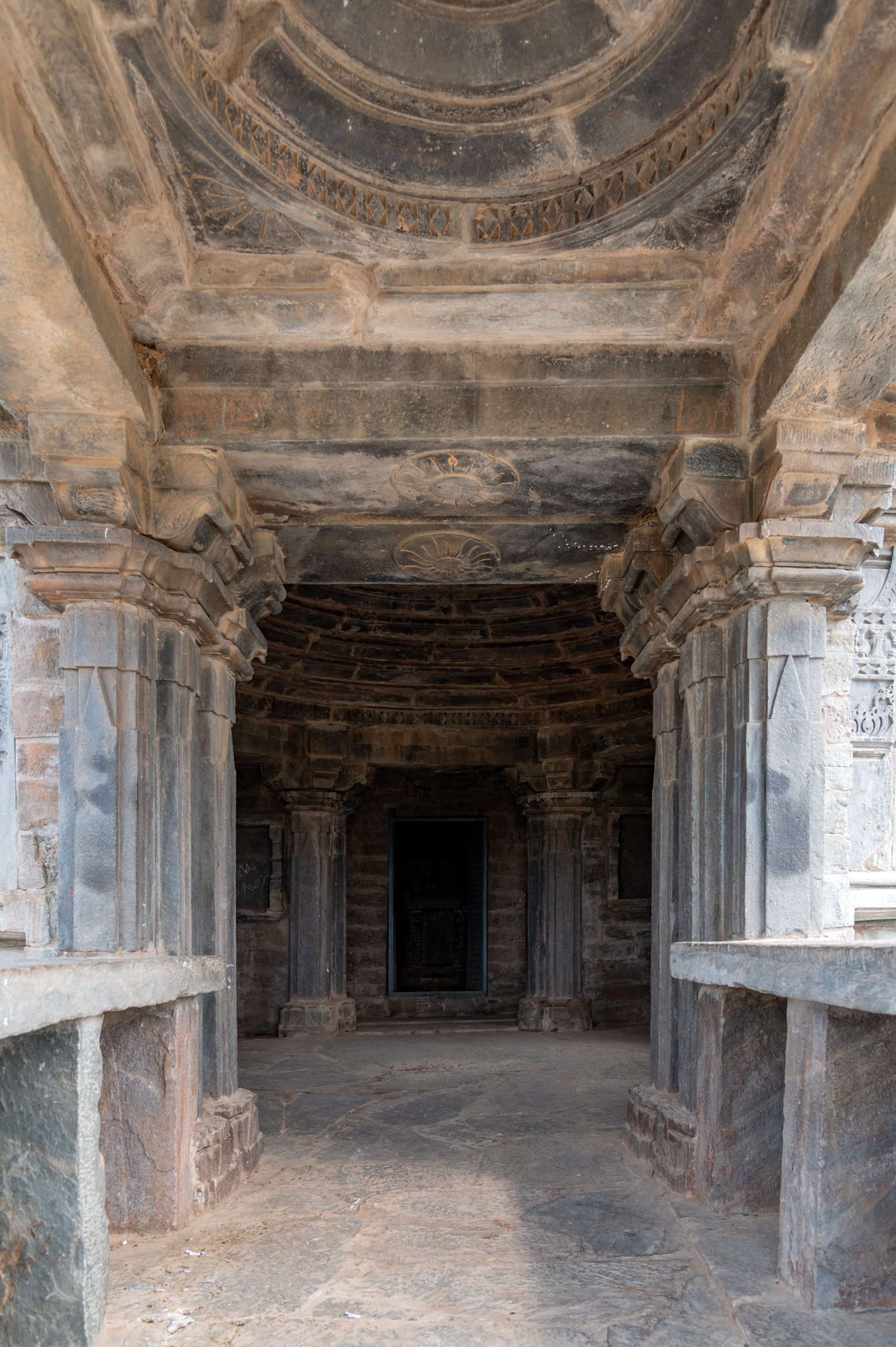 This is a view of the Shiva temple's interiors from its mukhamandapa (front porch). The pillars and walls of the temple interiors are plain.