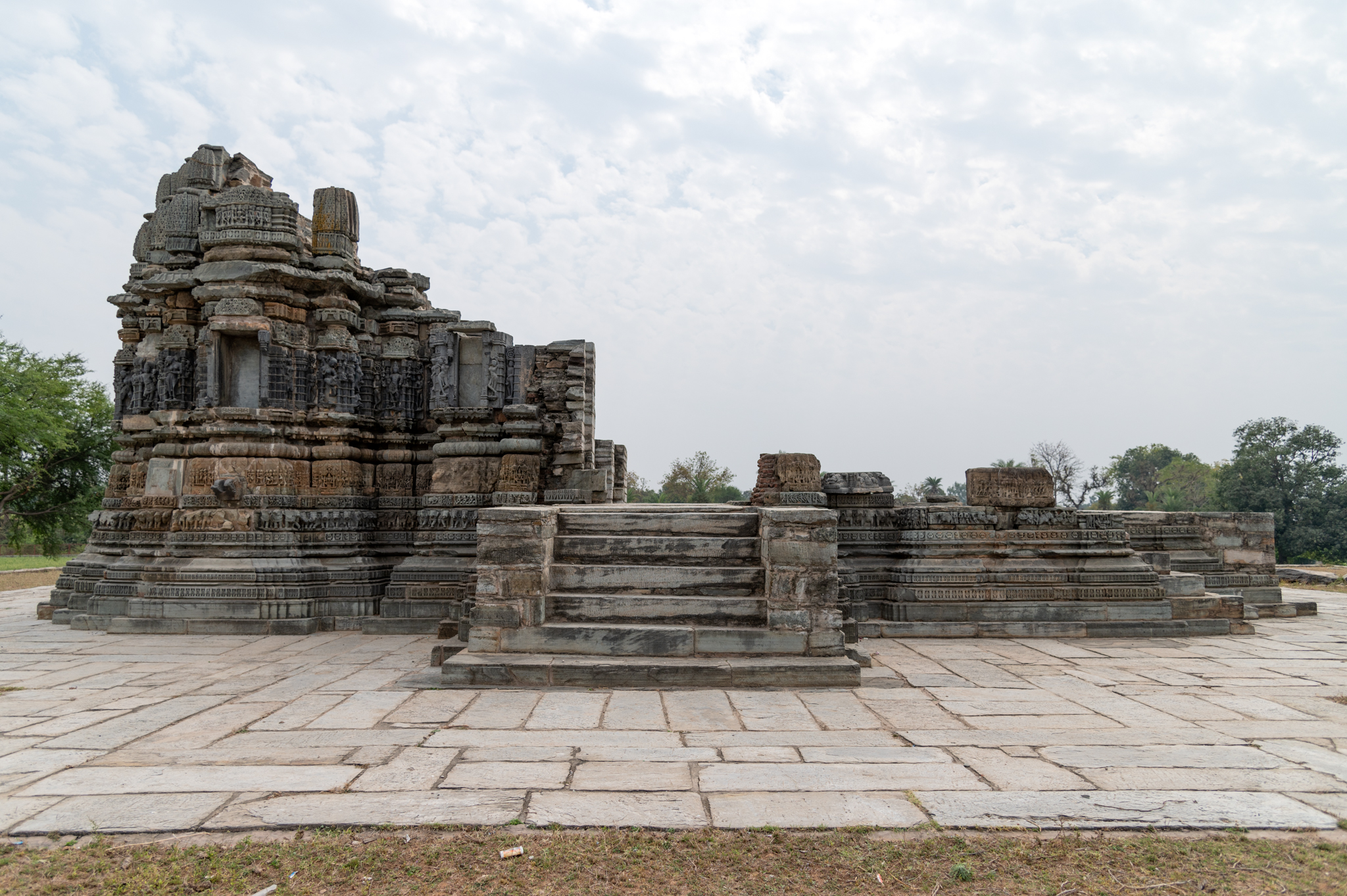 Seen here is the north-facing elevation of the Chaunsath Yogini Temple. At the centre of a high plinth, there is a single shrine temple of which only the garbhagriha (sanctum sanctorum) has partially survived. Originally, the temple must have had a garbhagriha, an antarala (vestibule and antechamber), and a mandapa (pillared hall) with attached mukhamandapas (front porch). This temple was constructed with two varieties of sandstone.