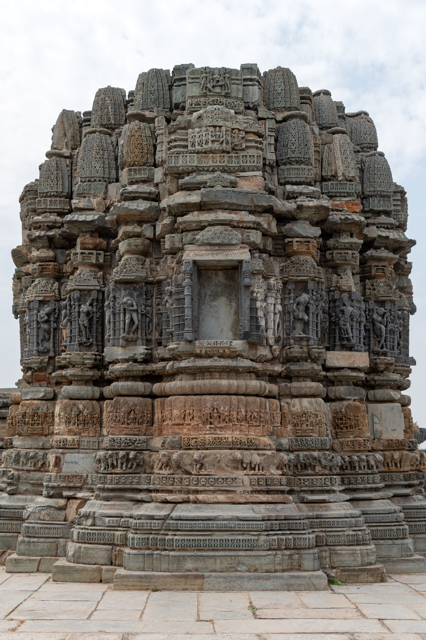 The east-facing elevation of the Chaunsath Yogini Temple is better preserved than other parts. In elevation, the temple has several basal mouldings. The intricate designs adorn all these mouldings with profuse carvings. Above this are the jangha (wall) and the remnants of the temple's shikhara (superstructure). The kumbha (pot) moulding from this temple's vedibandha (basal mouldings) is the most ornate, with leafy patterns on its edges and deities within framed niches on the front faces.