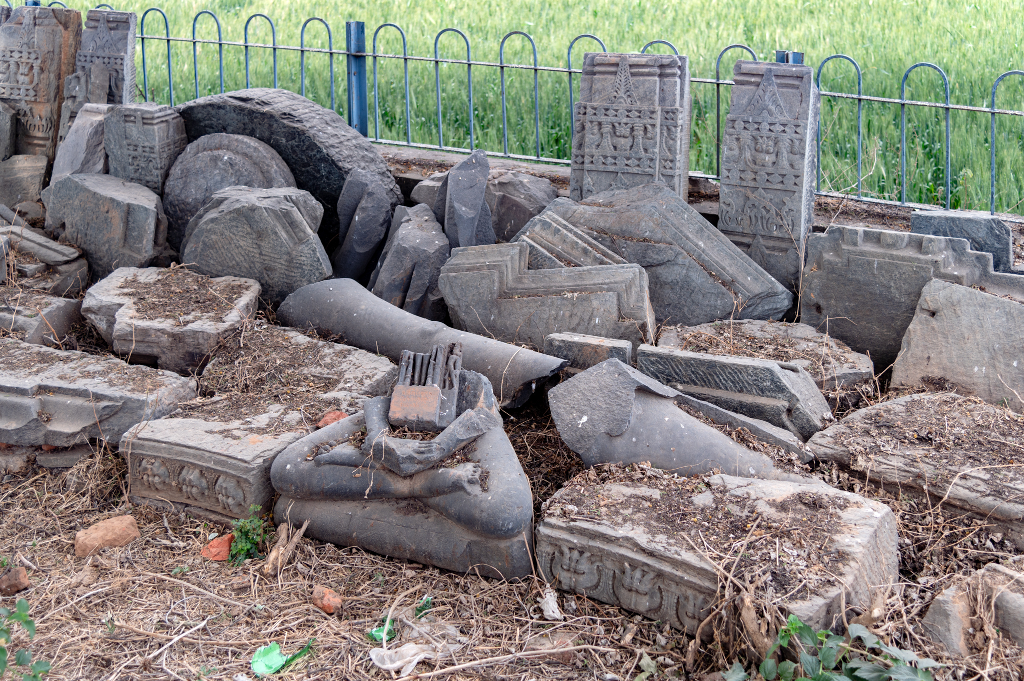 The scattered architectural fragments in the Jain temple complex, consisting of several architectural members along with a Jina sculpture seated in padmasana (lotus pedestal), are seen here. It is likely that all these architectural and sculptural remains originally formed part of the Jain temple complex. Because the Jain temple's central shrine is well preserved, the fragments of the wall with floral ornamentation might have been part of the side shrines in this complex.