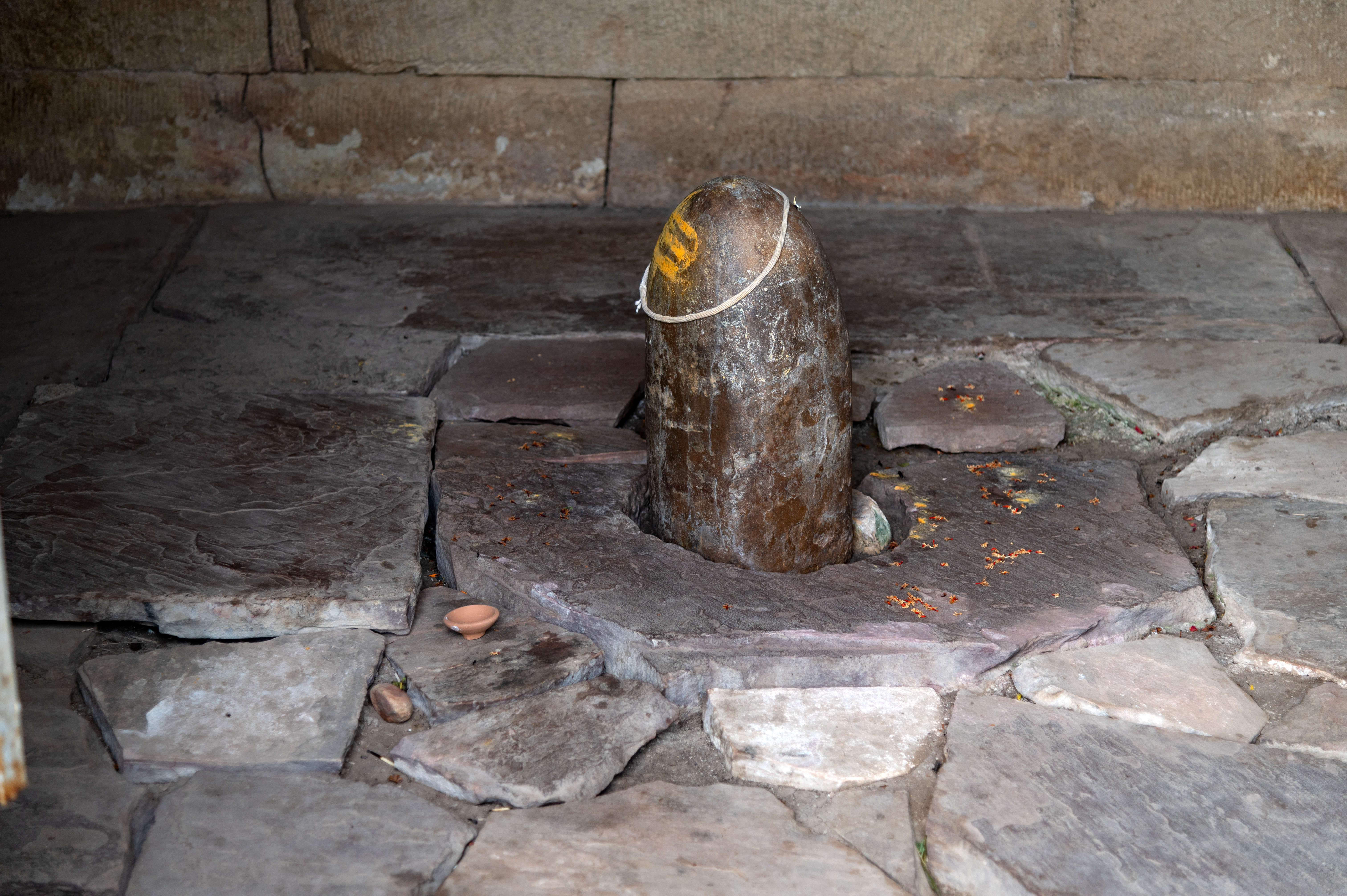 At the centre of the garbhagriha (sanctum sanctorum) of the Shiva Temple (Temple 1) in Cluster 1 a Shiva linga, without the yonipatta (womb-shaped base of the linga), is placed. The floor is not flat and shows the dilapidated condition of the temple. Sometimes the devotees worship the linga.