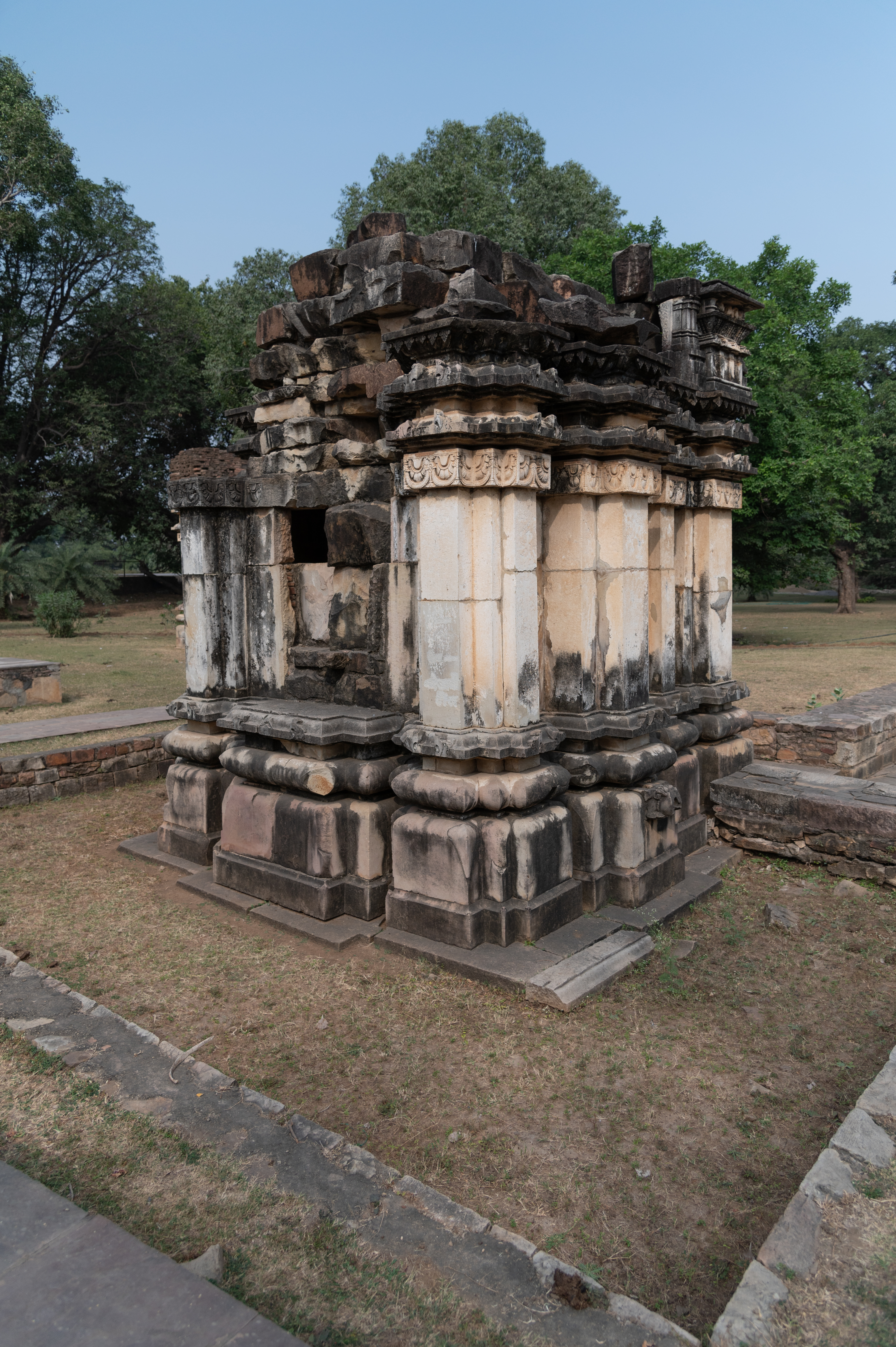 A view of an elevation of the Sheshashayi Vishnu Temple having basal mouldings, khura, kumbha (pot-shaped), kalasha (a pitcher), antarapatta (recesses between mouldings) and kapotapalika (cyma recta moulding). The jangha (wall) is plain, while the varandika (moulded parapet) consists of two kapotapalikas and an antarapatta, topped by a gaggarika. The shikhara (superstructure) above is severely damaged.