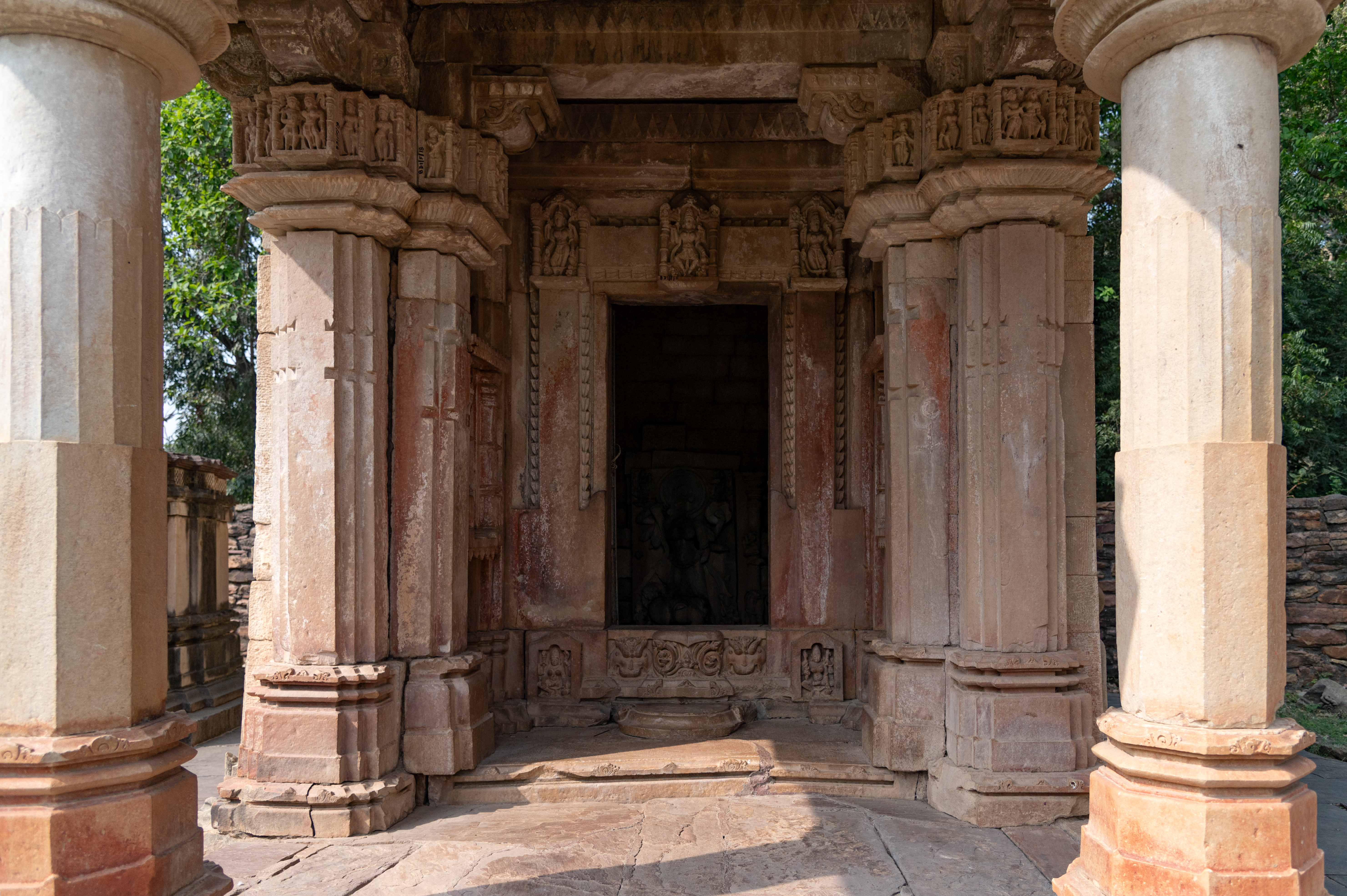 The mukhamandapa (front porch) of the Mahishasuramardini Temple, has two pillars at the front and two pilasters at the back. At the top of the shaft, an abacus is placed, carved with divine figures and female attendants. The mukhamandapa leads to the antarala (vestibule), which further leads to the entrance door of the garbhagriha (sanctum sanctorum). The door is carved and depicts Maheshwari, Brahmani, and Vaishnavi on the lintel.