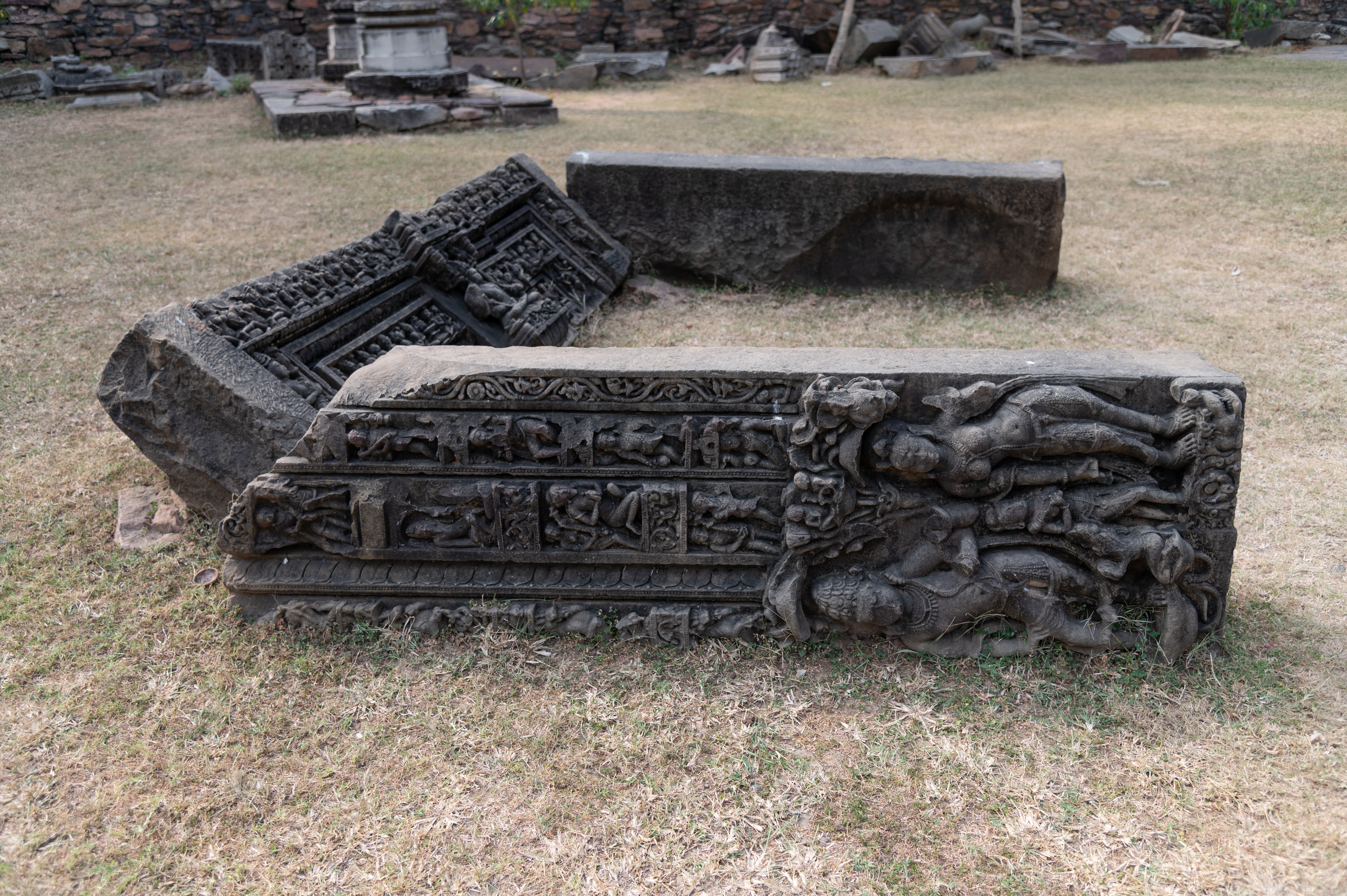 The doorframe is divided into panchshakhas (five vertical bands). At the bottom, the river goddesses Ganga and Yamuna, are depicted along with a Shaiva dvarapala (door guardian). The shakhas (vertical bands) display flower bands and moving outward the shakhas are carved with single male figures, mithunas (amorous couples), putrajaya (leaf motif), and vyalas (mythical lion-like hybrid creatures).