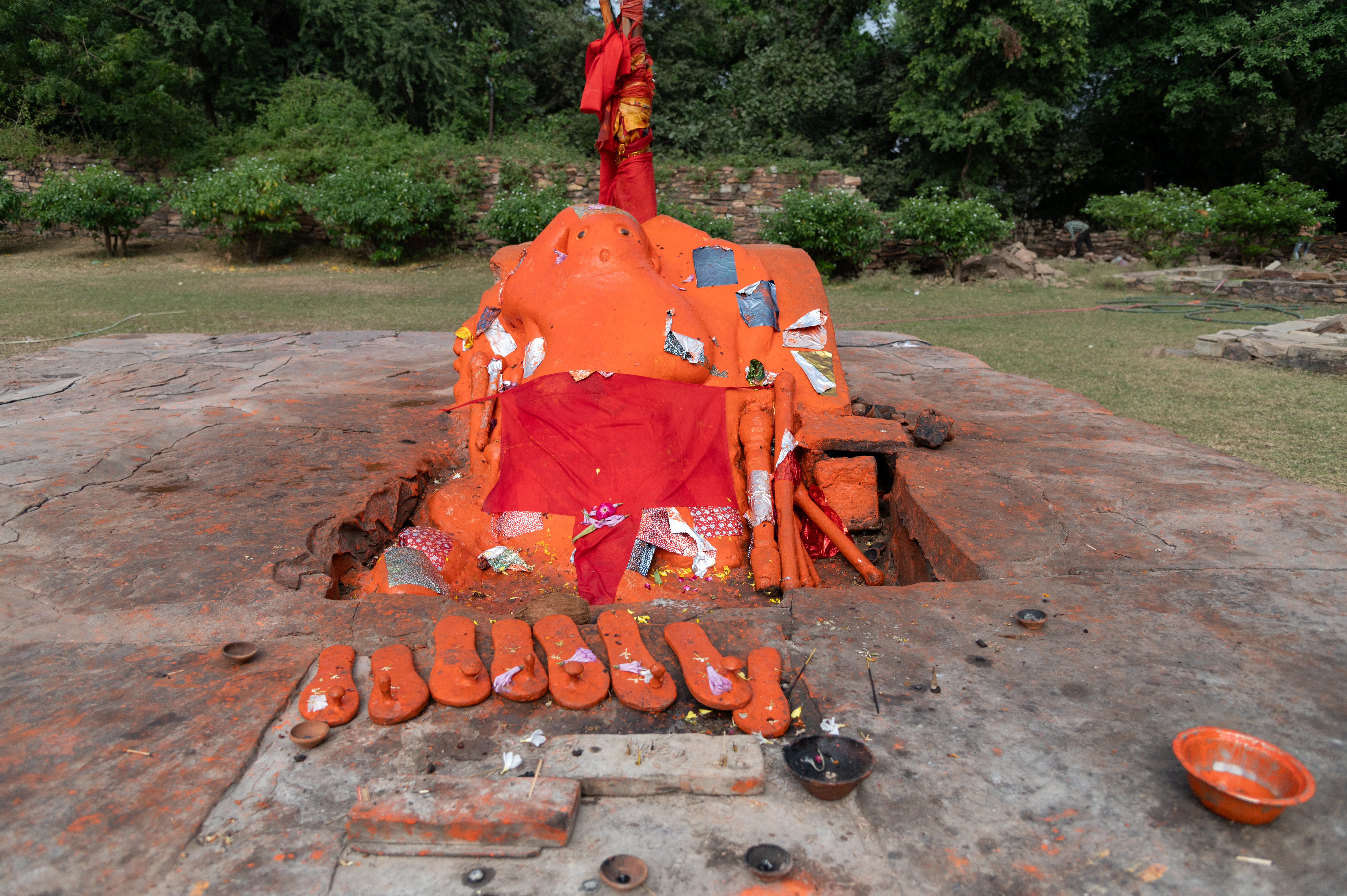 Many metal padukas (footwear) are placed on the platform on which Hanumana is placed. These padukas are offered by the devotees.