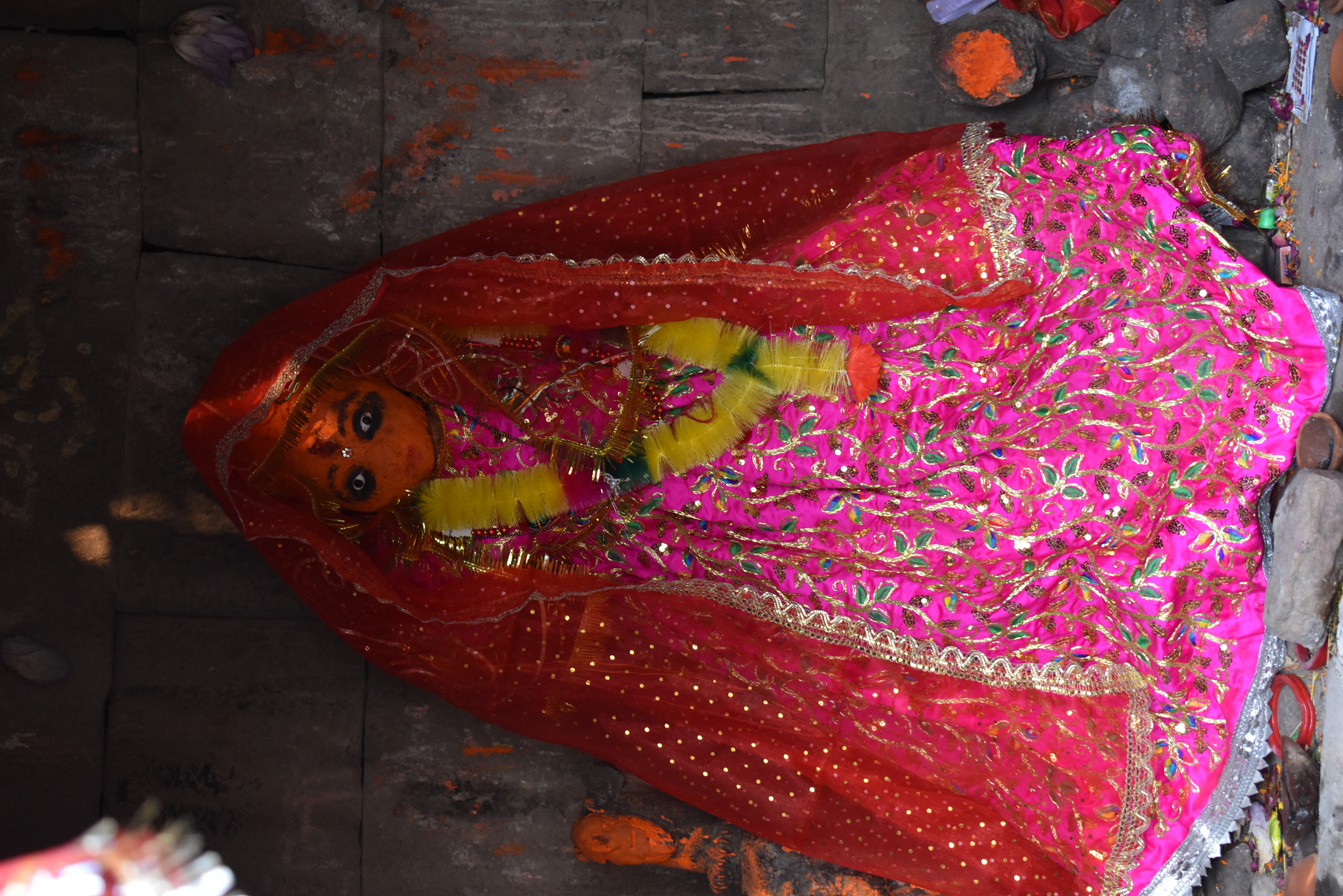 In the garbhagriha (sanctum sanctorum) of the Mahishasuramardini Temple (Temple 9), a pedestal holds a sculpture of a Goddess. The Goddess is worshipped by the locals, as indicated by the vermilion on her face and the clothes that the sculpture is wrapped in.