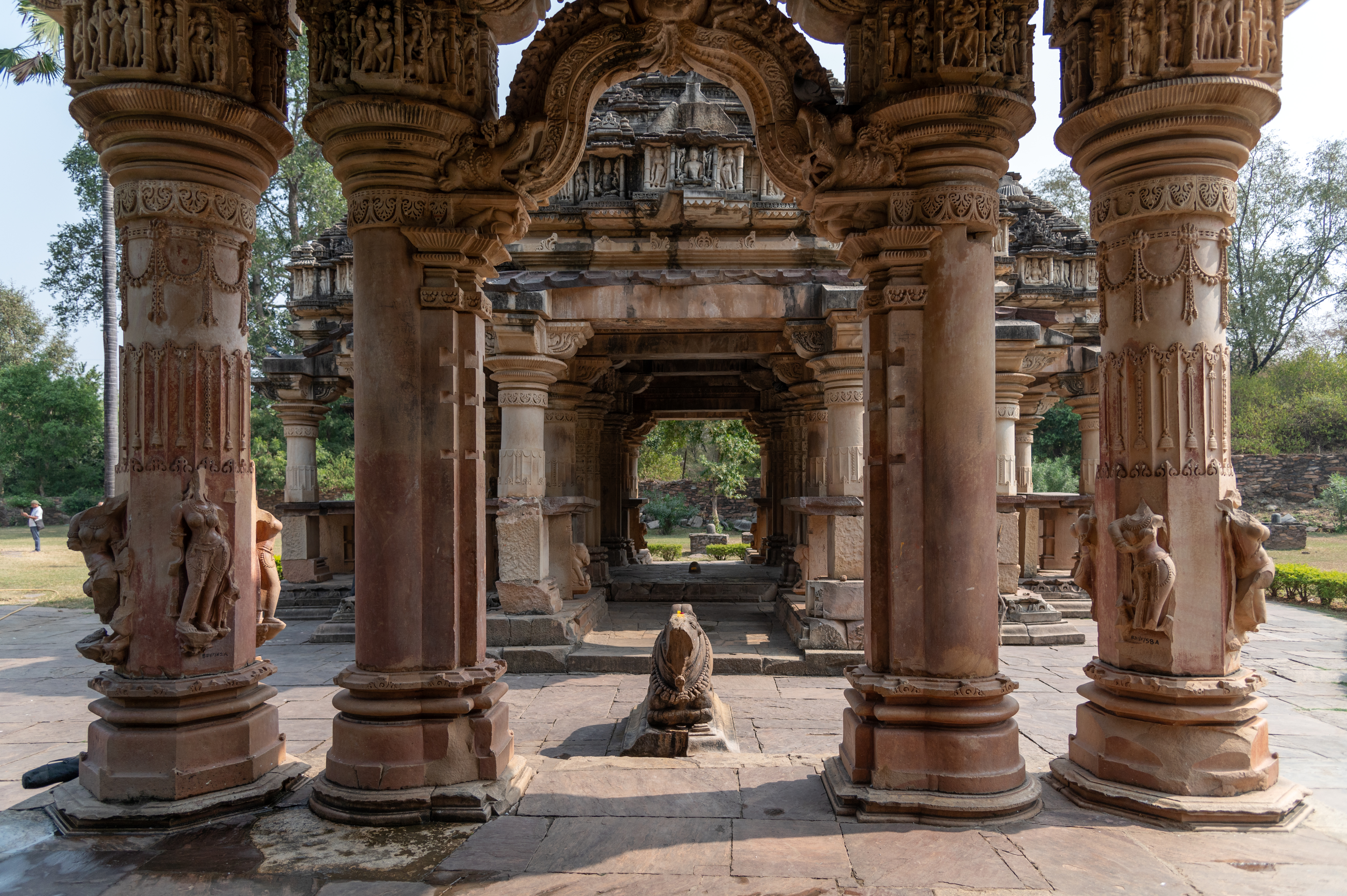 The mukhamandapa (front porch) is an open hall with a magnificent entrance dominated by a makara-torana (ornamental arch adorned with intricate carvings of mythical crocodile creatures). The pillars of the mukhamandapa are carved with the figures of sursundaris (celestial maidens) and passionate couples, symbolizing the worldly realm. This stands in contrast to the main sanctum where the divine resides in darkness.