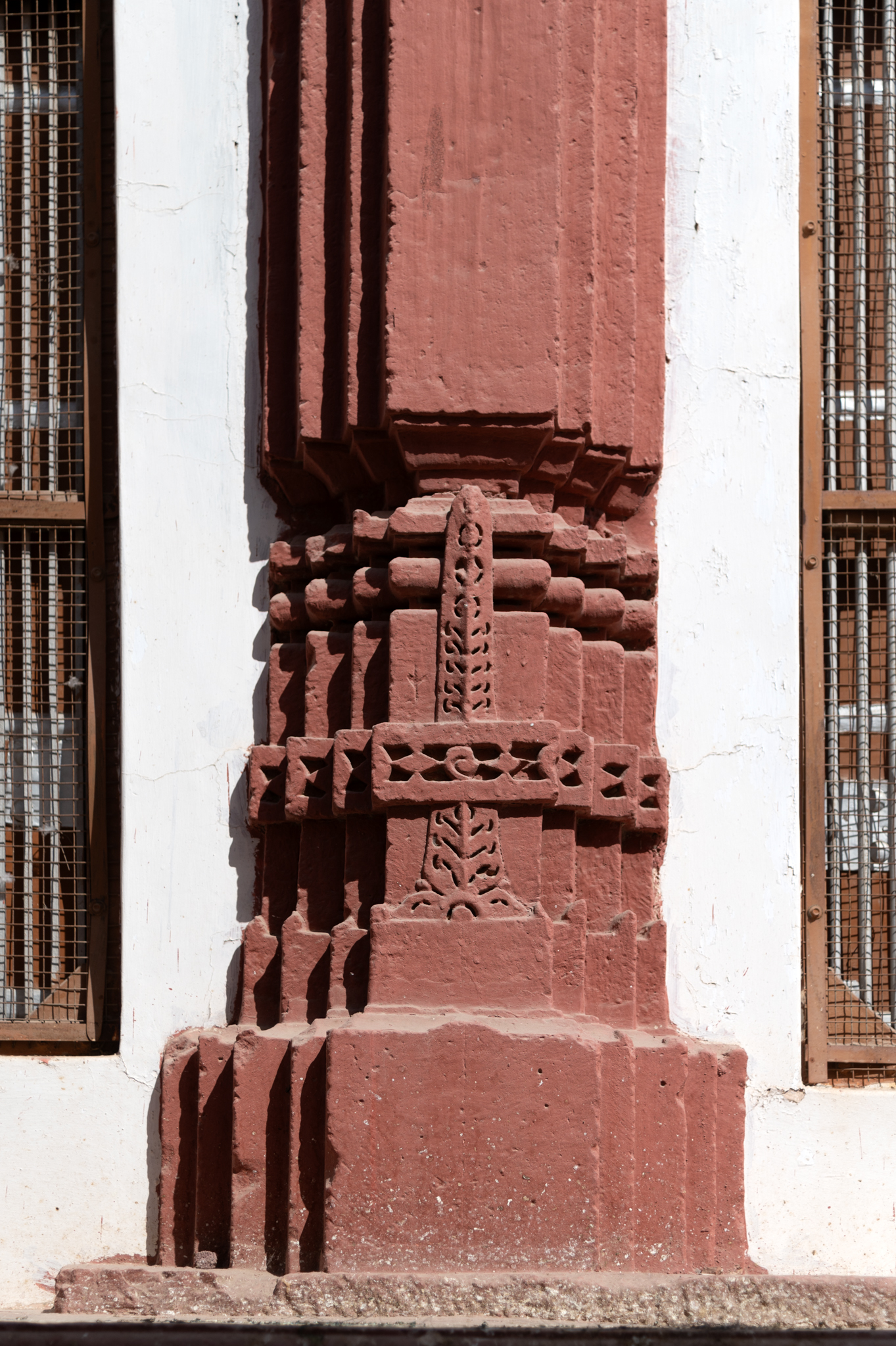 Details of the carving and ornamentation of the pilaster base, which is in the west, south and north-facing elevations of the temple. The pilasters are identical in design. They have a wider base, slender and are relatively plain. The pilaster base has an elongated vertical floral motif with a horizontal band of diamond-like motifs.