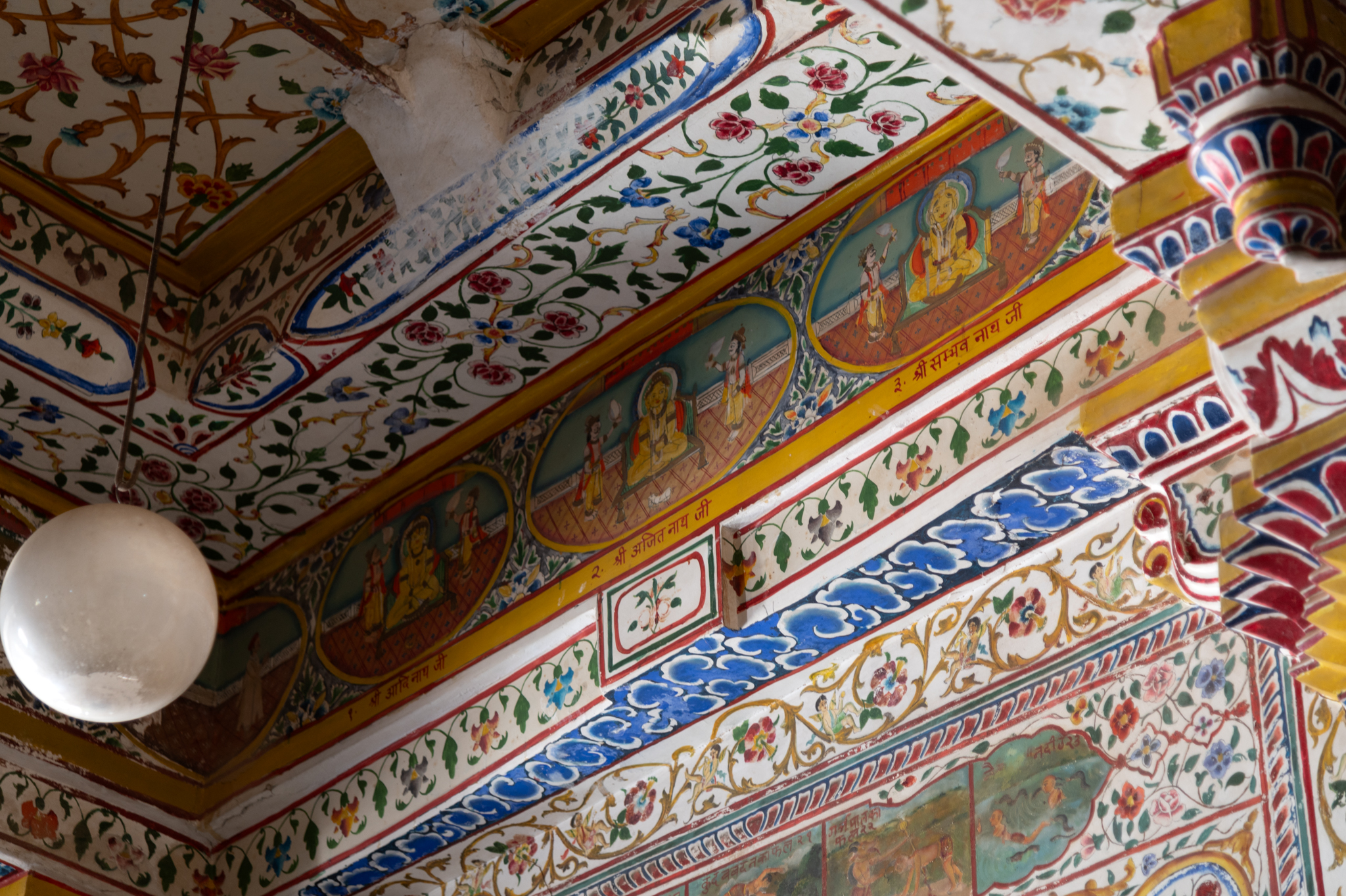 Just above the beams of the antarala (antechamber), there is a strip or band that runs across the entire rectangular ceiling. This band has the depiction of twenty-four Tirthankaras with their vahanas (rides). The Tirthankaras are drawn in their order, from viewers left to right, all along the ceiling of the antechamber, starting with Rishabnatha.