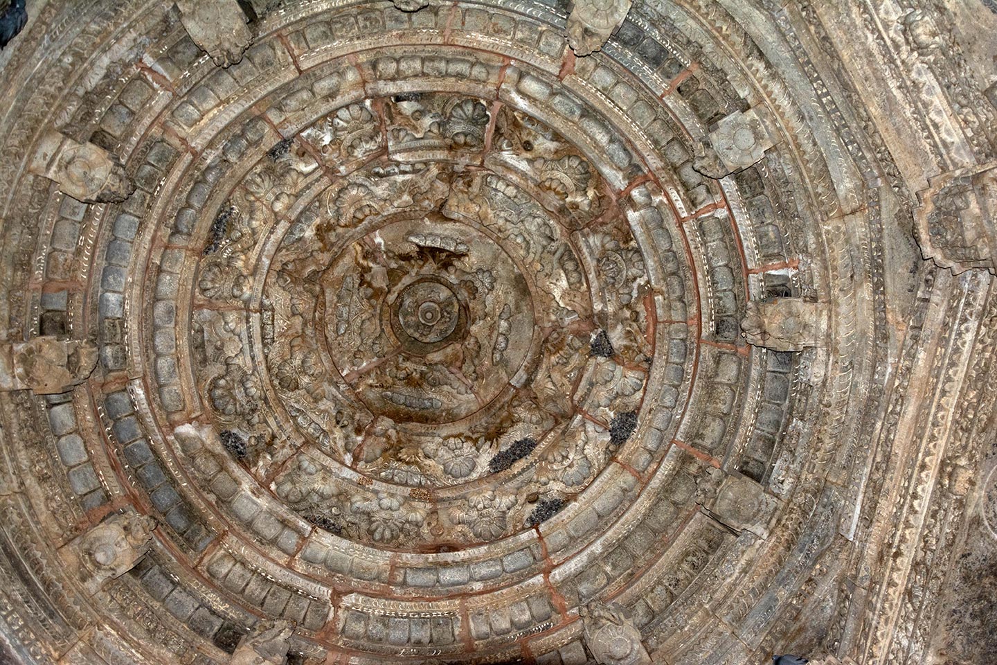 The ceiling of the central hall or the mahamandapa (pillared hall) is of the nabhichhanda variety, characterized by a band of five concentric overlapping circles decorated with lotus petals and other floral designs. The top of the ceiling is embellished with a full-blown lotus, complete with a padmakesara (stem-like) pendant.