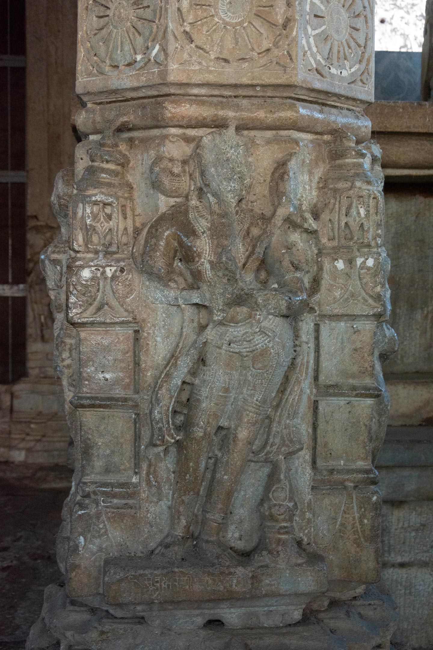 A heavily adorned royal figure, depicted in the tribhanga pose, exhibits damaged hands. Whether this represents the patron, King Vigraharaja IV, remains a matter of pure speculation.