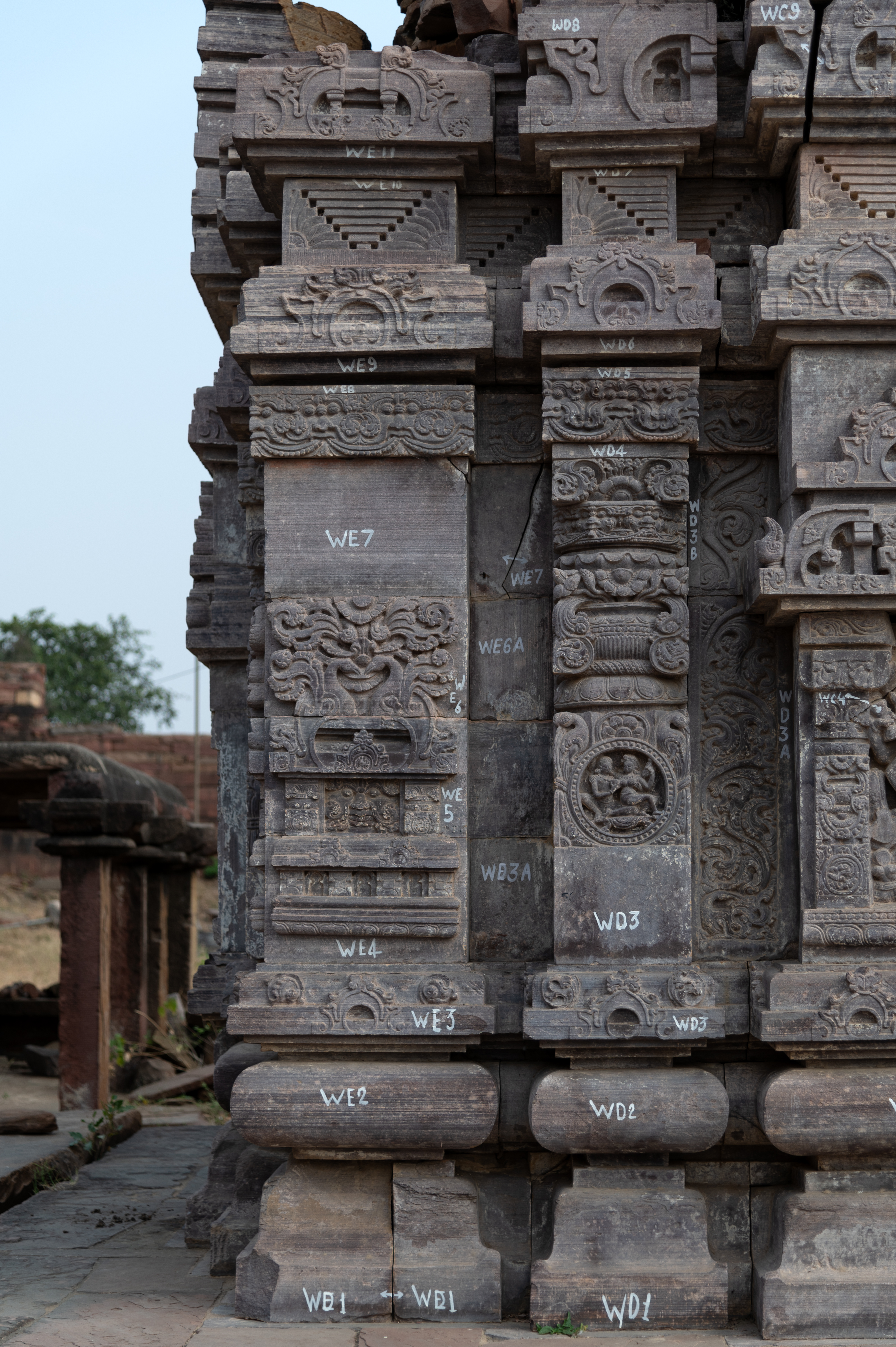 The details of one of the shrines from the Triple Shrine to the northwest of Mahanaleshwar Temple are noteworthy. The vedibandha's base moldings are plain and devoid of ornamentation. At the jangha (wall) level, the intermediate and corner projections have different designs. They also vary in size. Proportionately, the corner projection is one-third of the central wide projection, while the intermediate projections are half of the central projection.