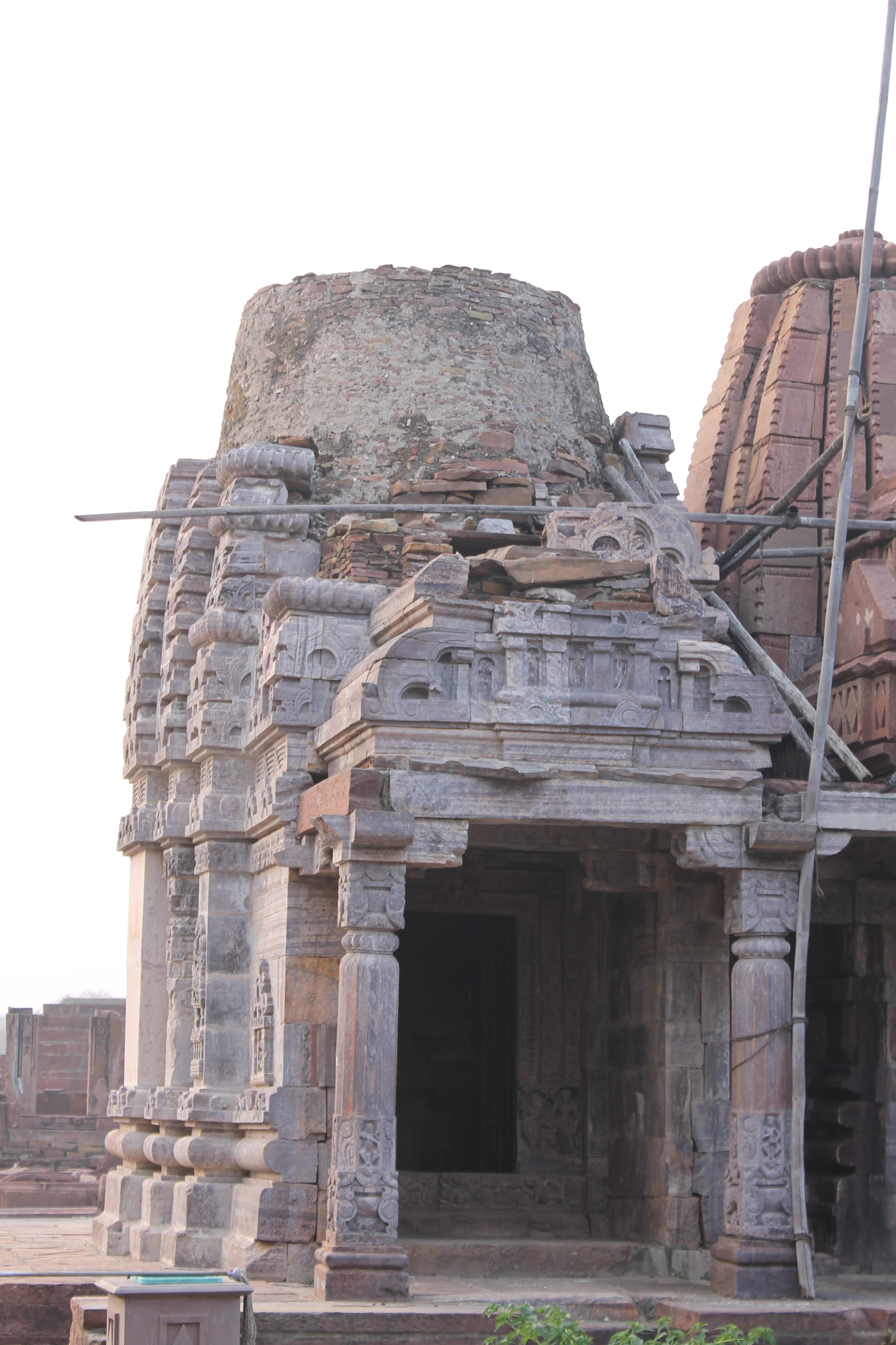 This is an east-facing view of the side shrine from the Triple Shrine in the Mahanaleshwar temple complex. Bricks form the core of the temple's shikhara (superstructure).