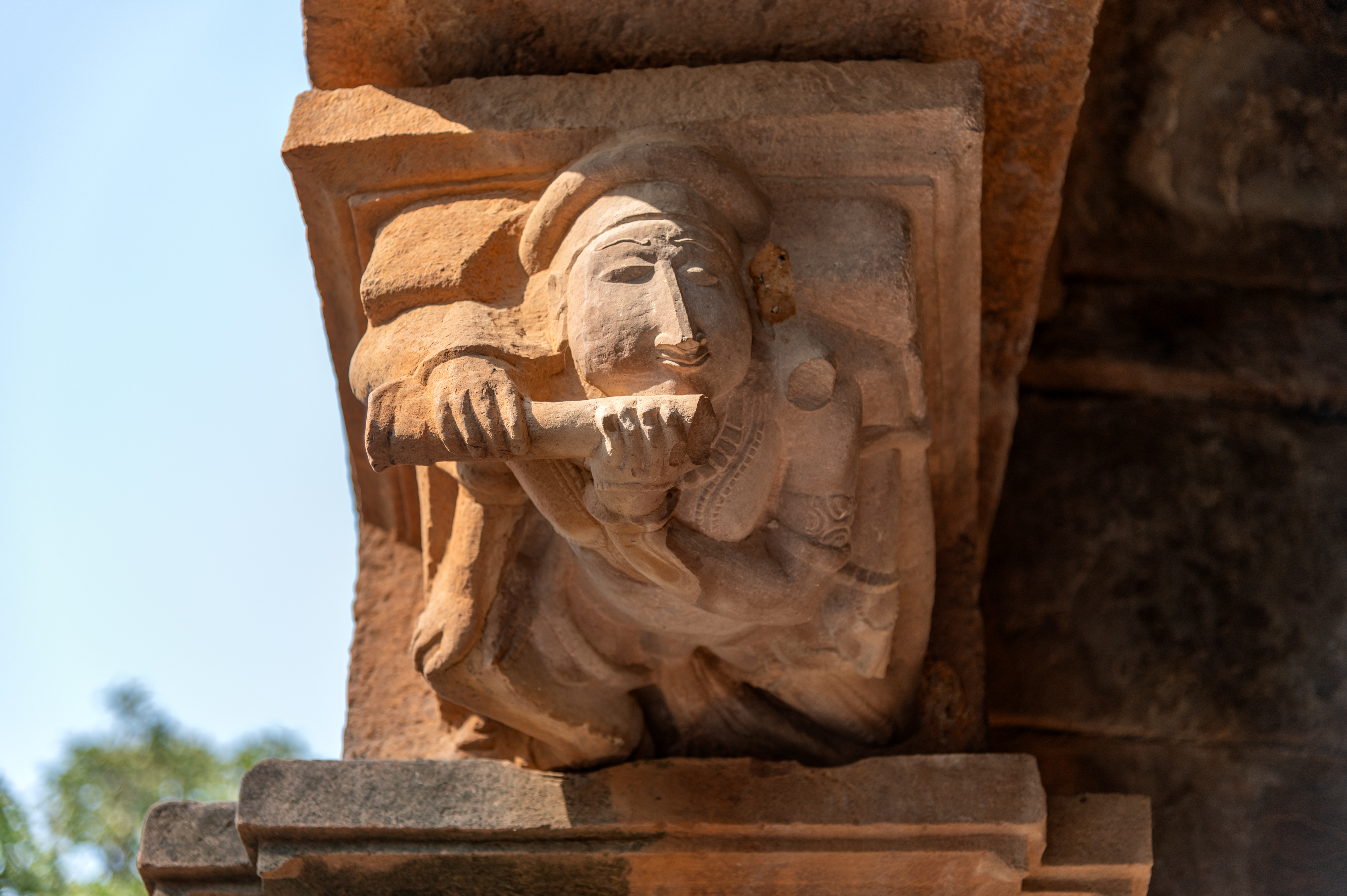 At the upper part of both pilasters, bharavahakas (load bearers) are depicted. Interestingly, the bharavahaka on the right pilaster is shown playing the flute.