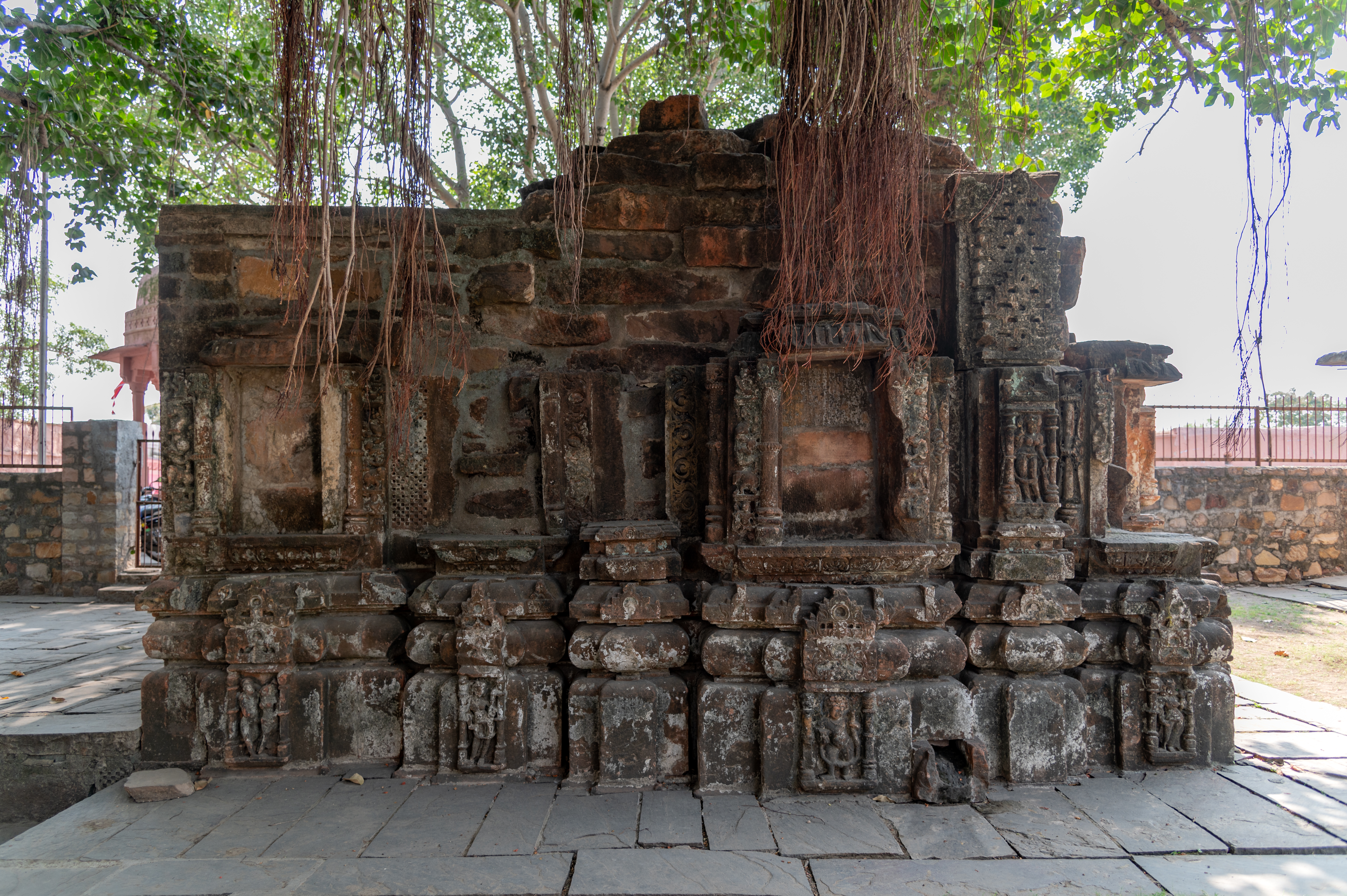 All of the niches on the north elevation of Shiva Temple 1's garbhagriha (sanctum sanctorum) are currently empty. The shikhara (superstructure) of the temple has collapsed with time, and only remnants of stone blocks can be seen.