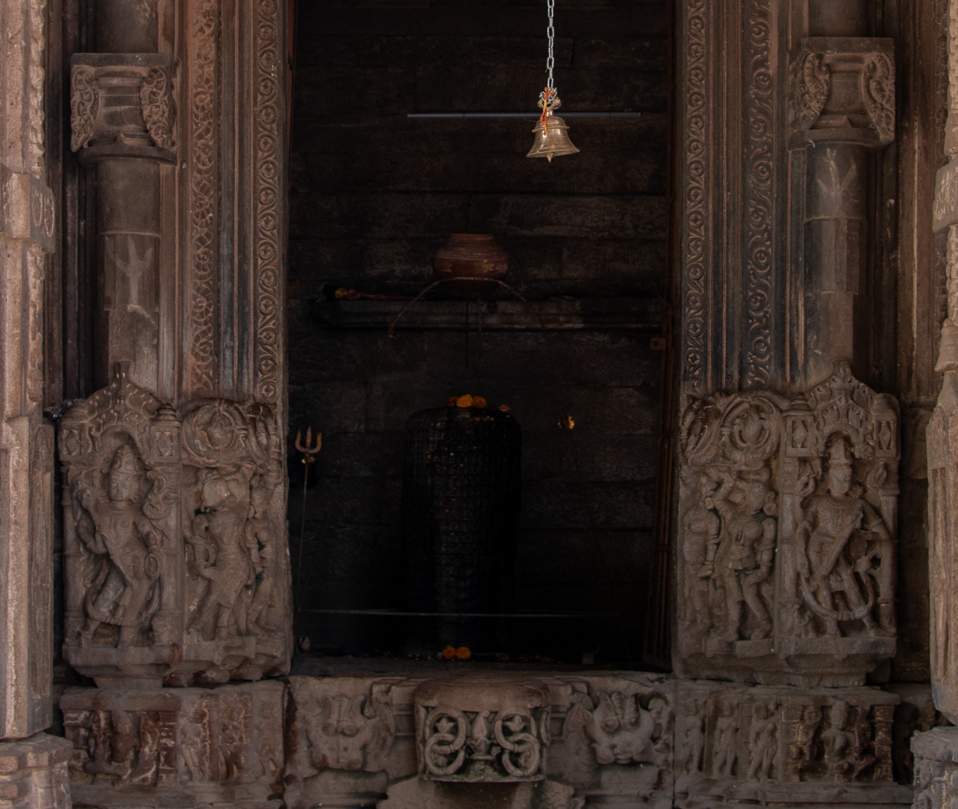 Image 10: The doorframe of the garbhagriha (sanctum sanctorum) is adorned with two female figures, while the central positions on either side are occupied by Shaiva dvarapalas (door guardians). Completing the ensemble is the figure of Kubera, the God of wealth.