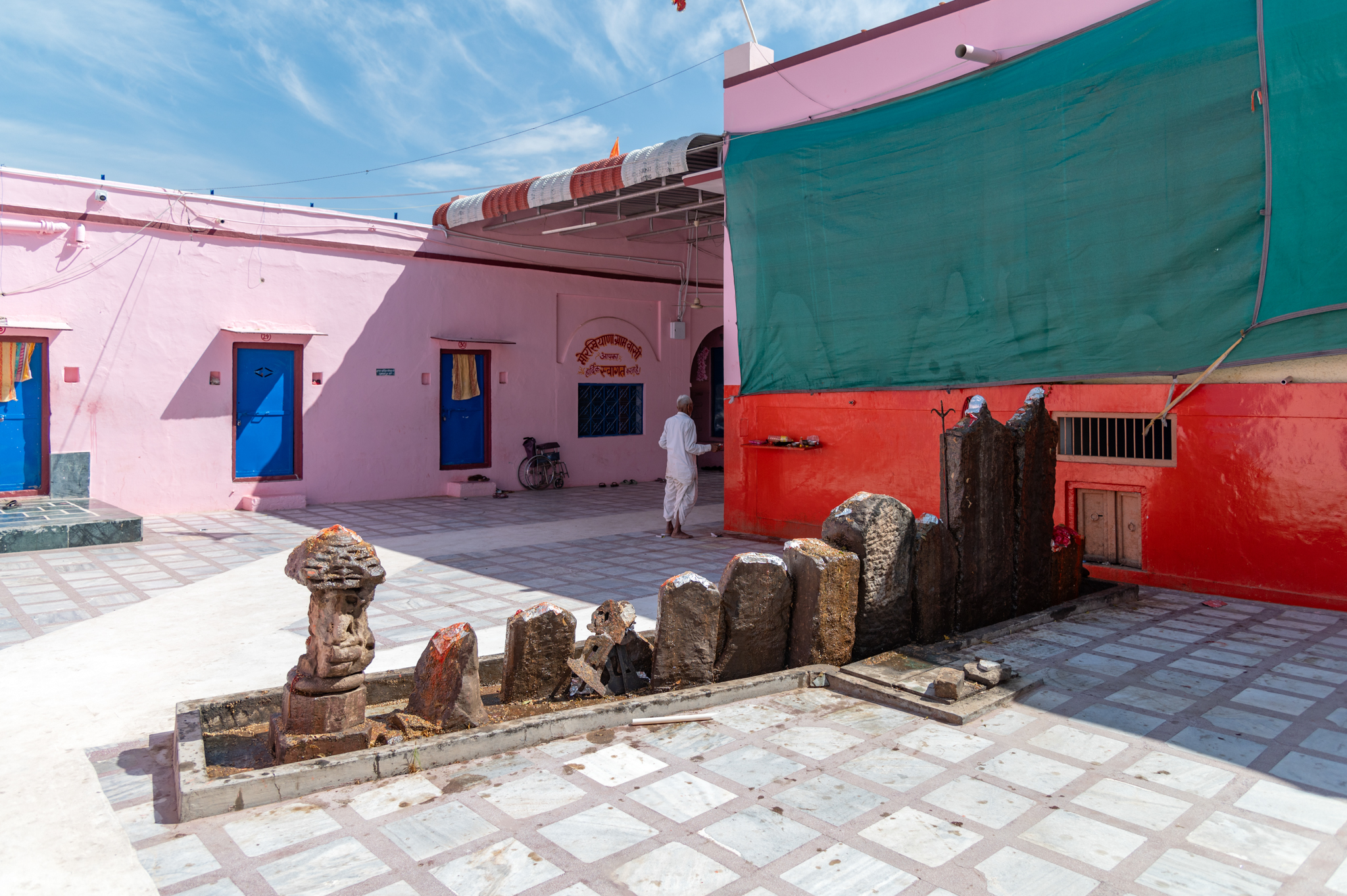 Seen here is the modern mandapa (pillared hall) of the Suswani Mata Temple. To its south side are some historical fragments consisting of Hero stones, which are worshipped as veeron ke pathar (stones of heroic people). The original location of these fragments is unknown, but today, they are an integral part of the rituals performed by devotees visiting the temple.