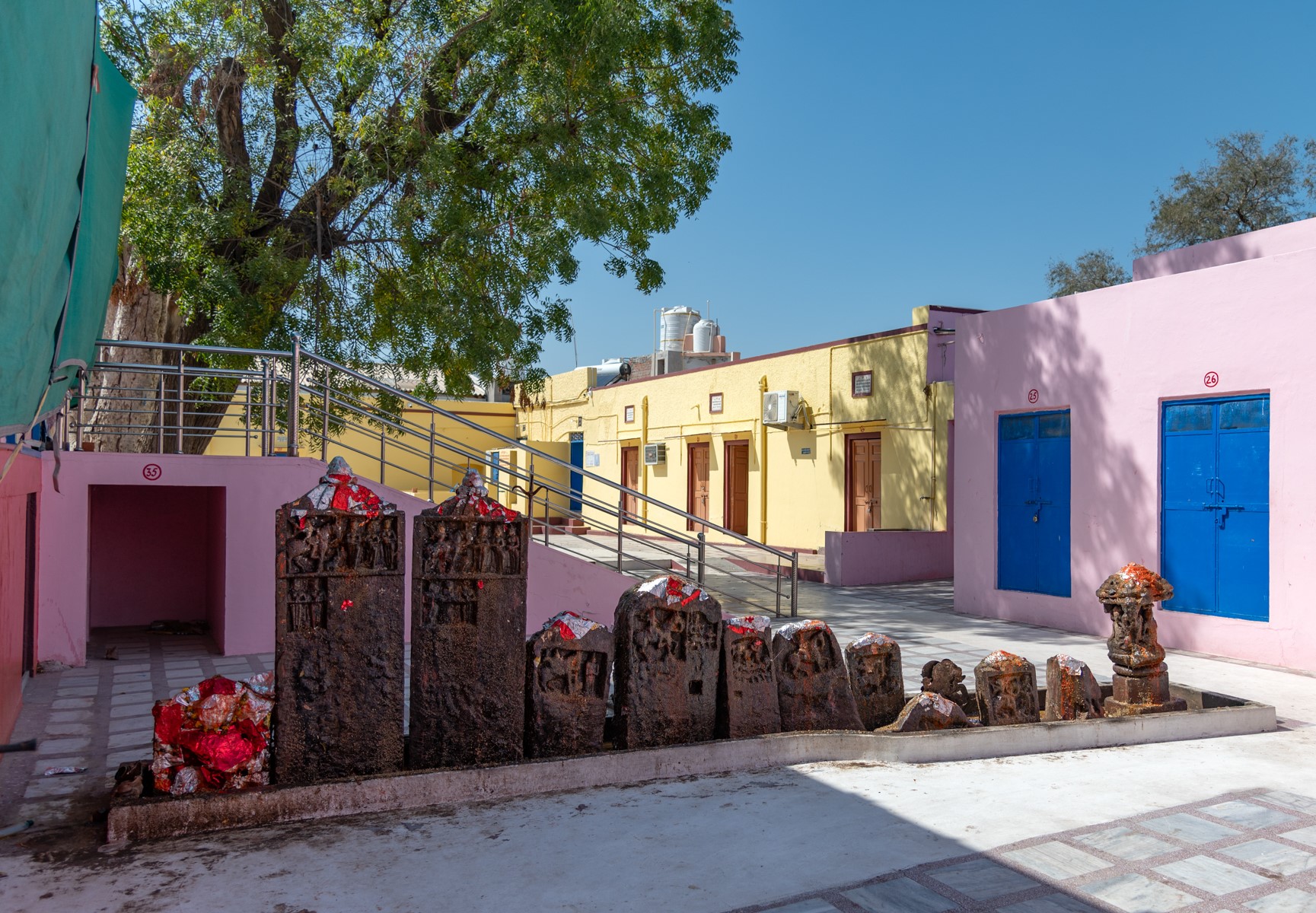 Twelve stone slab fragments of hero stones and sculptures are placed on a low pedestal. People worship the stones of brave souls and offer grains and sweets after smearing them with vermilion. The stone fragments are often rubbed with oil, which has seeped into the incisions of the inscriptions. Due to continuous worship, the intricate details of the slabs are lost.