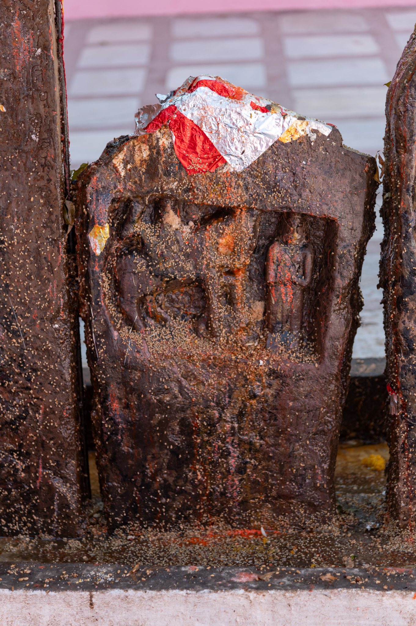 Another small stone fragment, likely a part of larger hero stones, is now housed in the premises of the Suswani Mata Temple. This fragment is noticeably less ornate compared to the larger stone slabs. It depicts only two figures one is the hero mounted on a horse, and the other is a figure standing with folded hands. The human figures are carved within rectangular niches on the fragment. There are no remaining traces of writing left on the lower side of this hero stone fragment.