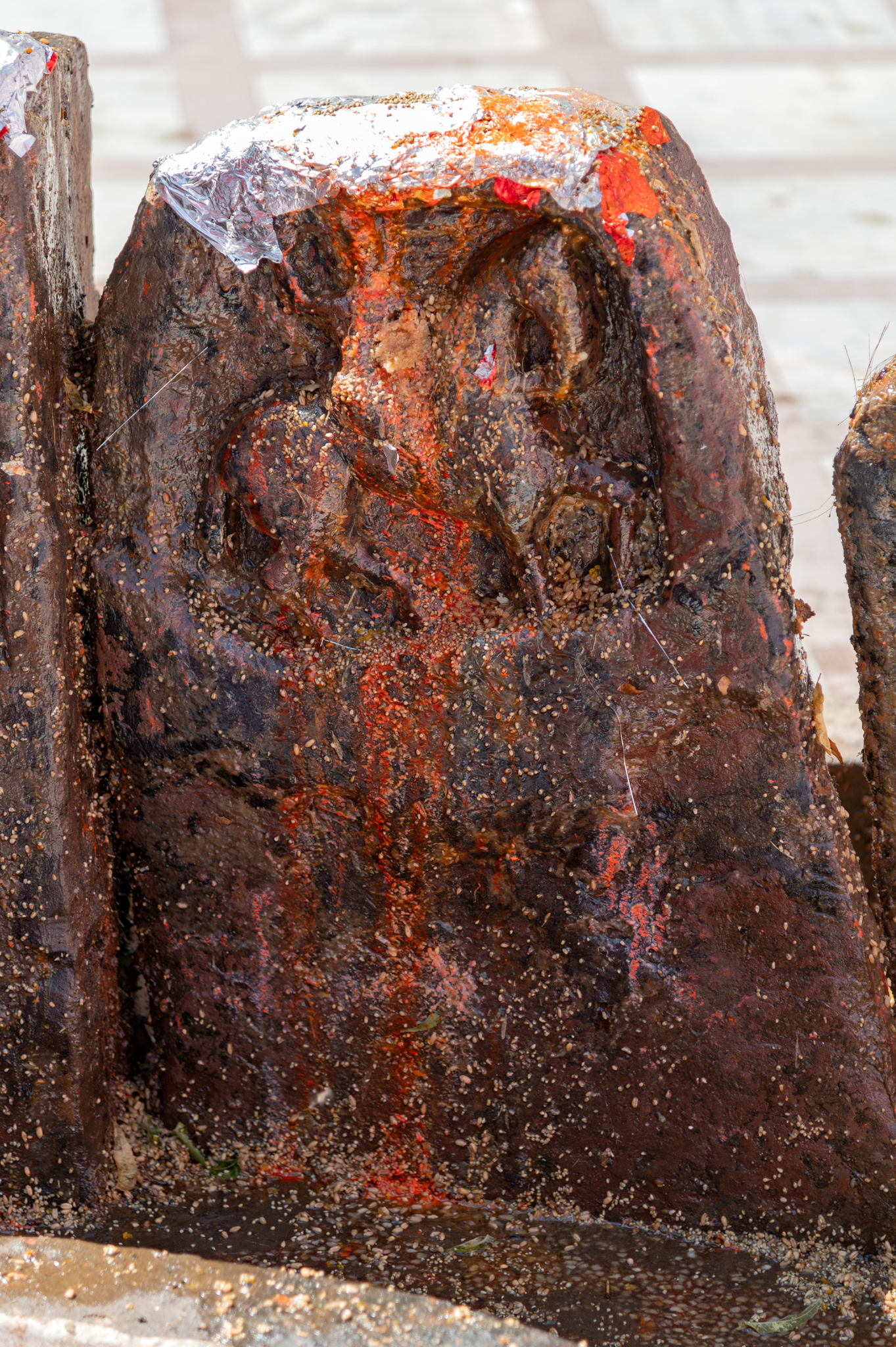  Seen here is a smaller hero stone, characterized by its simple ornamentation and minimal figural depiction. It features only a human figure mounted on horseback, representing the deceased hero. The plain stone surface of the hero stones may have originally included epigraphical etchings.