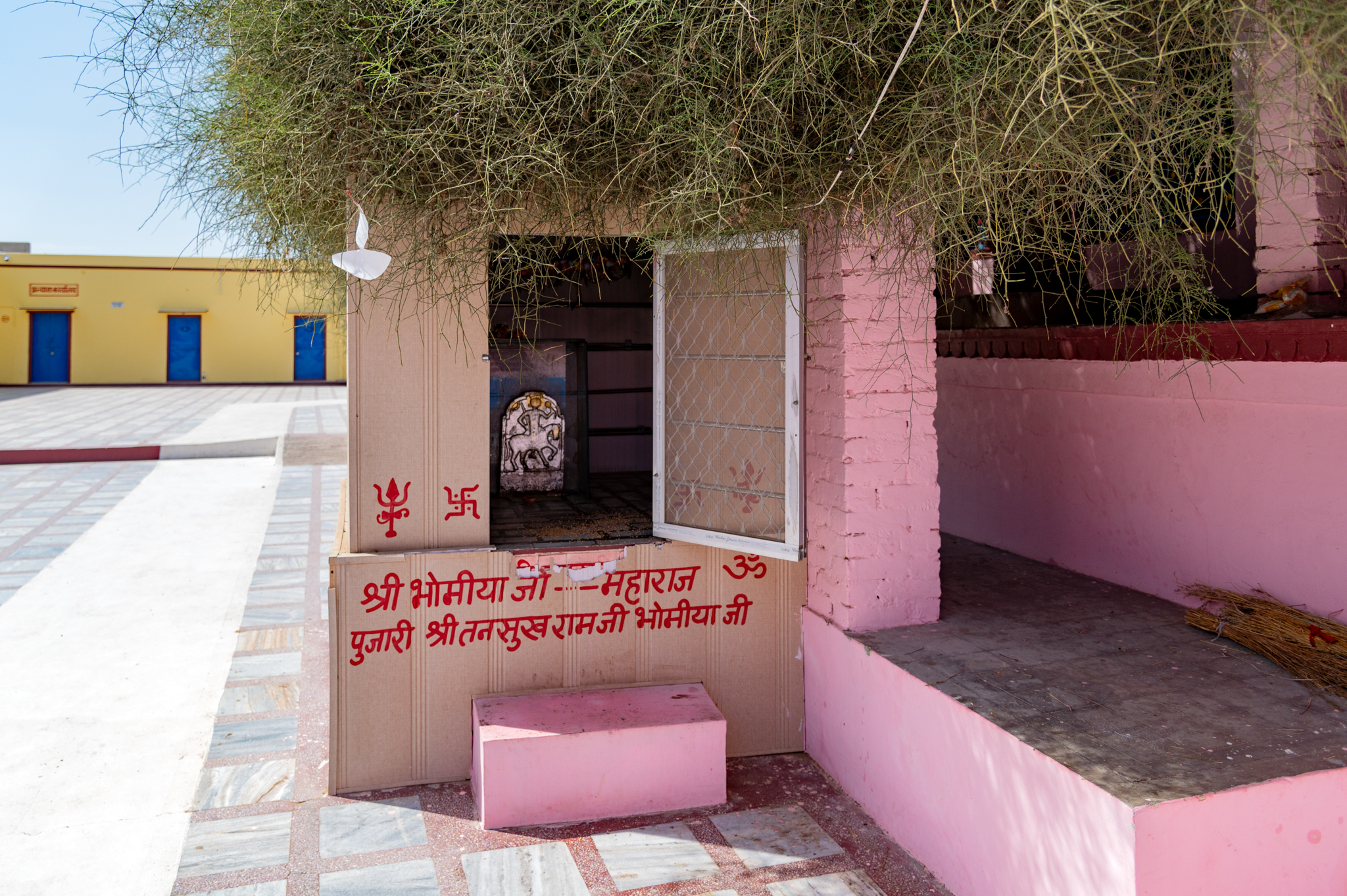 Seen here is a side shrine of the Bhomiya Maharaja on the premises of the Suswani Mata Temple next to the sacred Kera tree. The Kera tree is believed to be the spot where Suswani Ma manifested herself and eventually stayed at the location of the present-day temple.
