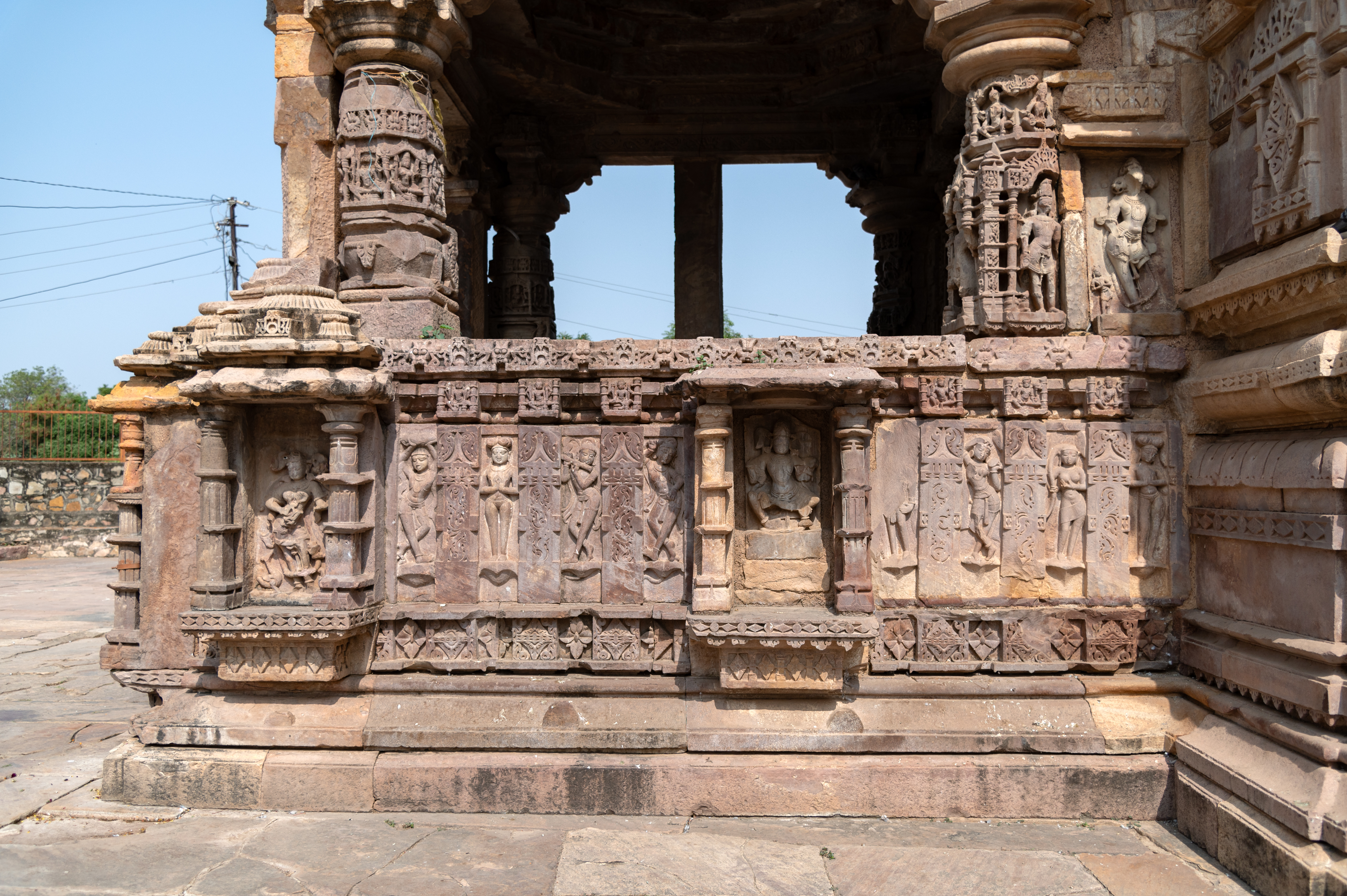 Image 6: The mukhamandapa (front porch) of the Mahakal Temple features a kakshasana (seat backs) adorned with niches housing divine figures, including deities like Brahma and Kaumari. Interwoven among these divine figures are depictions of ascetics, musicians, and surasundaris (celestial damsels).