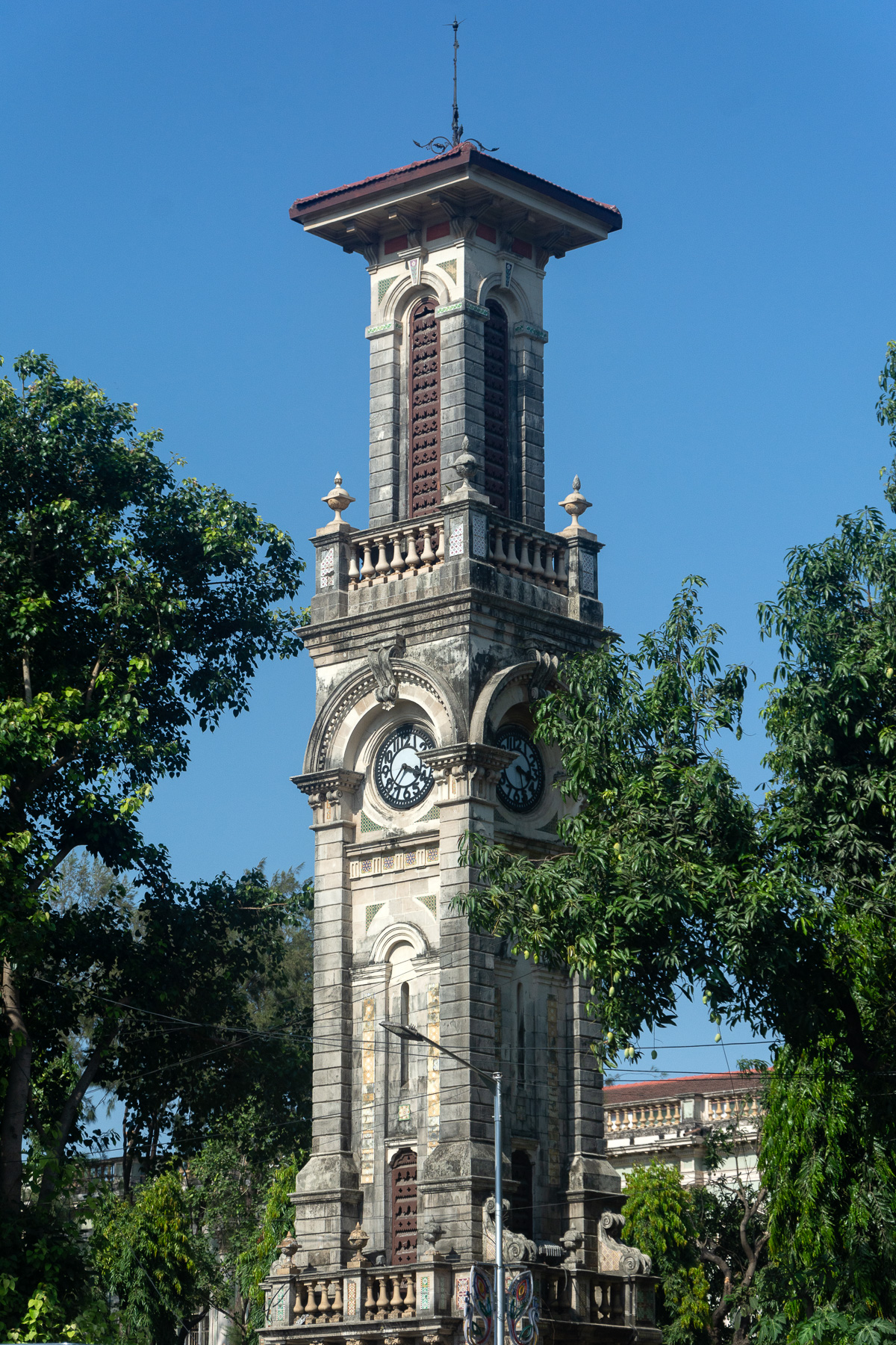 The David Sassoon clock tower originally stood outside the gates of Victoria Garden, by the side of the main road, then known as Parel Road (now BR Ambedkar Road). 