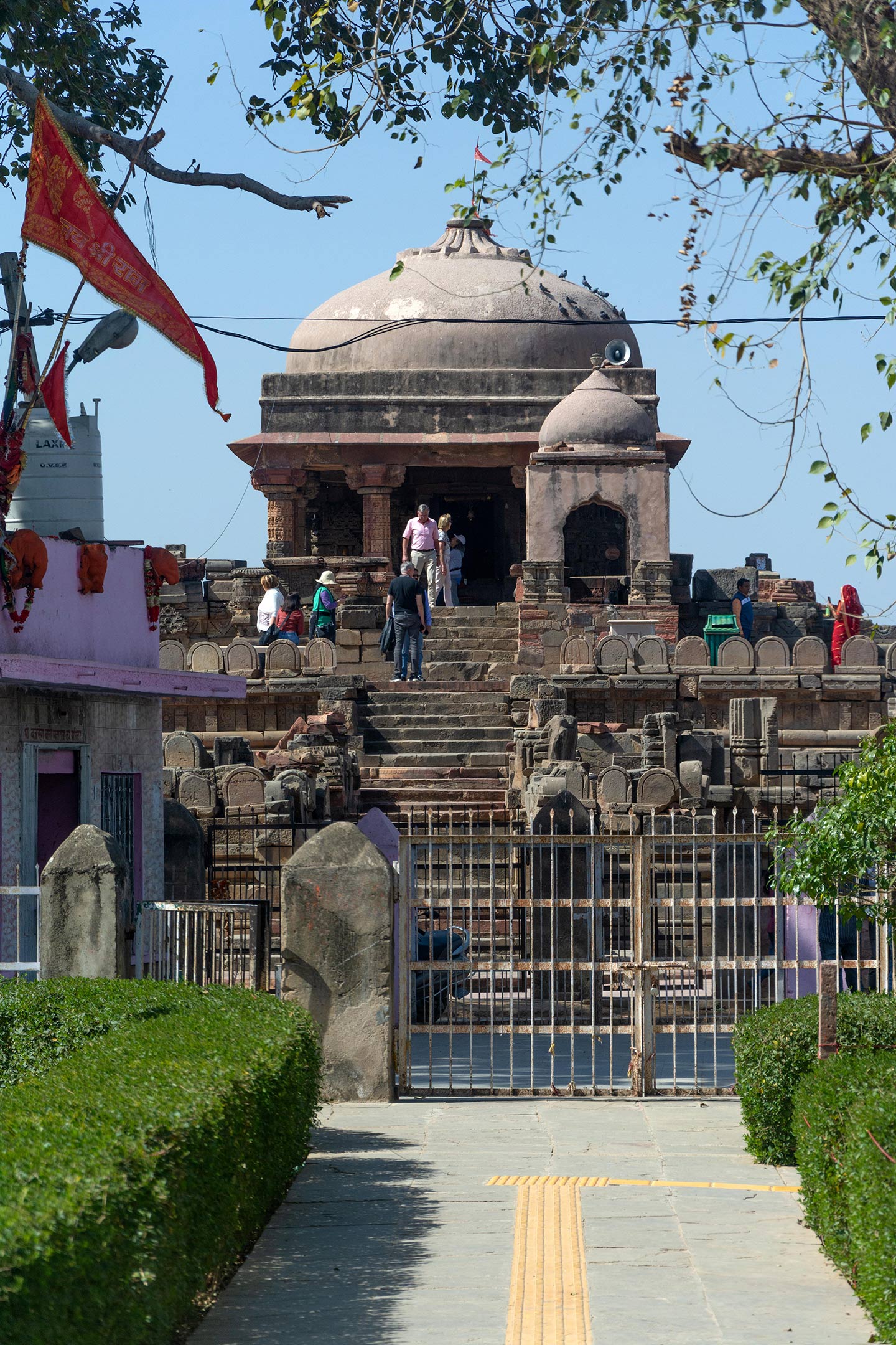 The front view of the Harshatmata Temple features steps that lead to the temple from ground level. Also seen is the smaller Nandi shrine in front of the main temple.